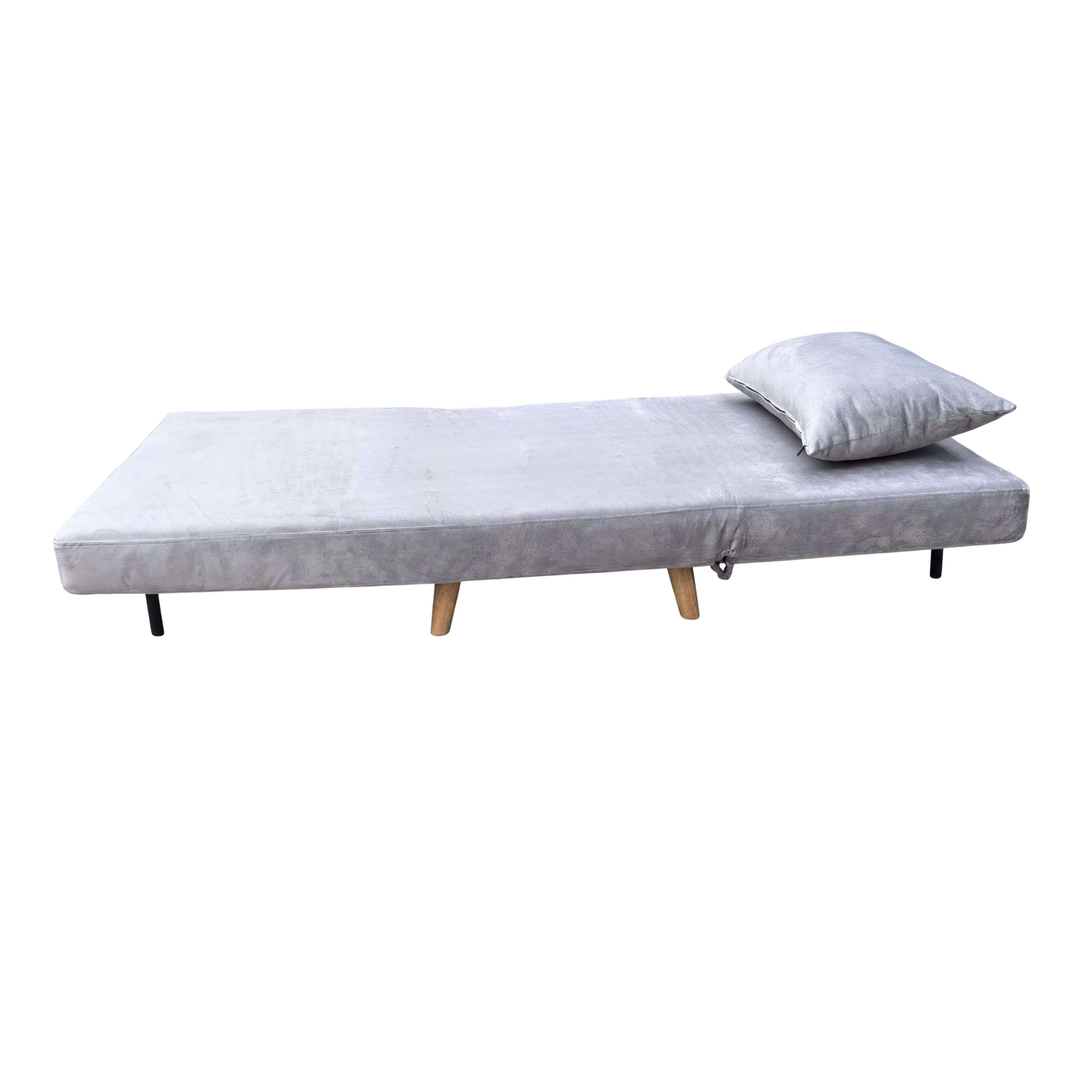 Un sofá cama gris con un cojín sobre fondo blanco.