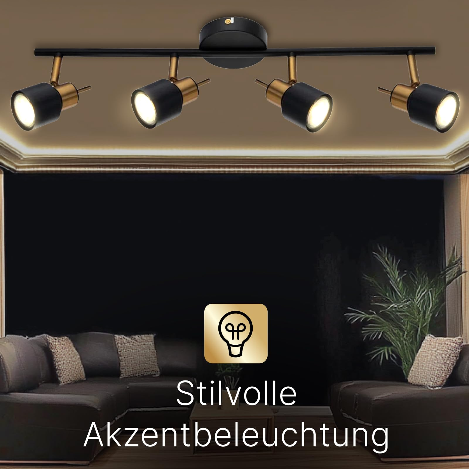 Ein schwarzer Deckenstrahler mit vier gold-schwarzen Spots leuchtet über einem Sofa.