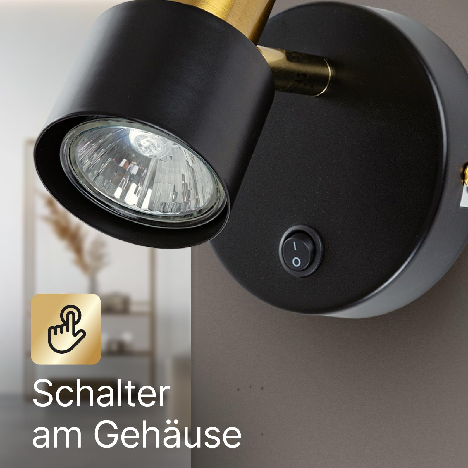 Schwarz-goldene Wandleuchte mit Kippschalter am Gehäuse.