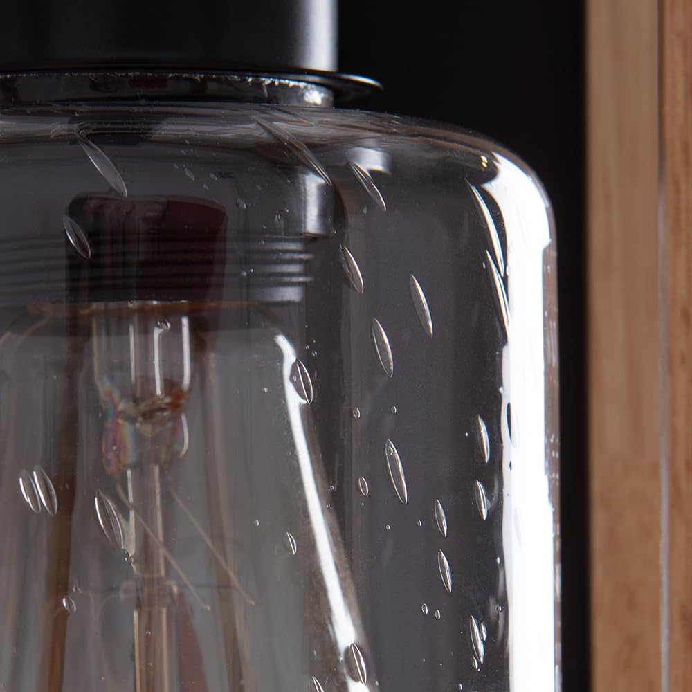 Ein Teil einer Lampe mit einem Glaszylinder und einer Glühbirne.