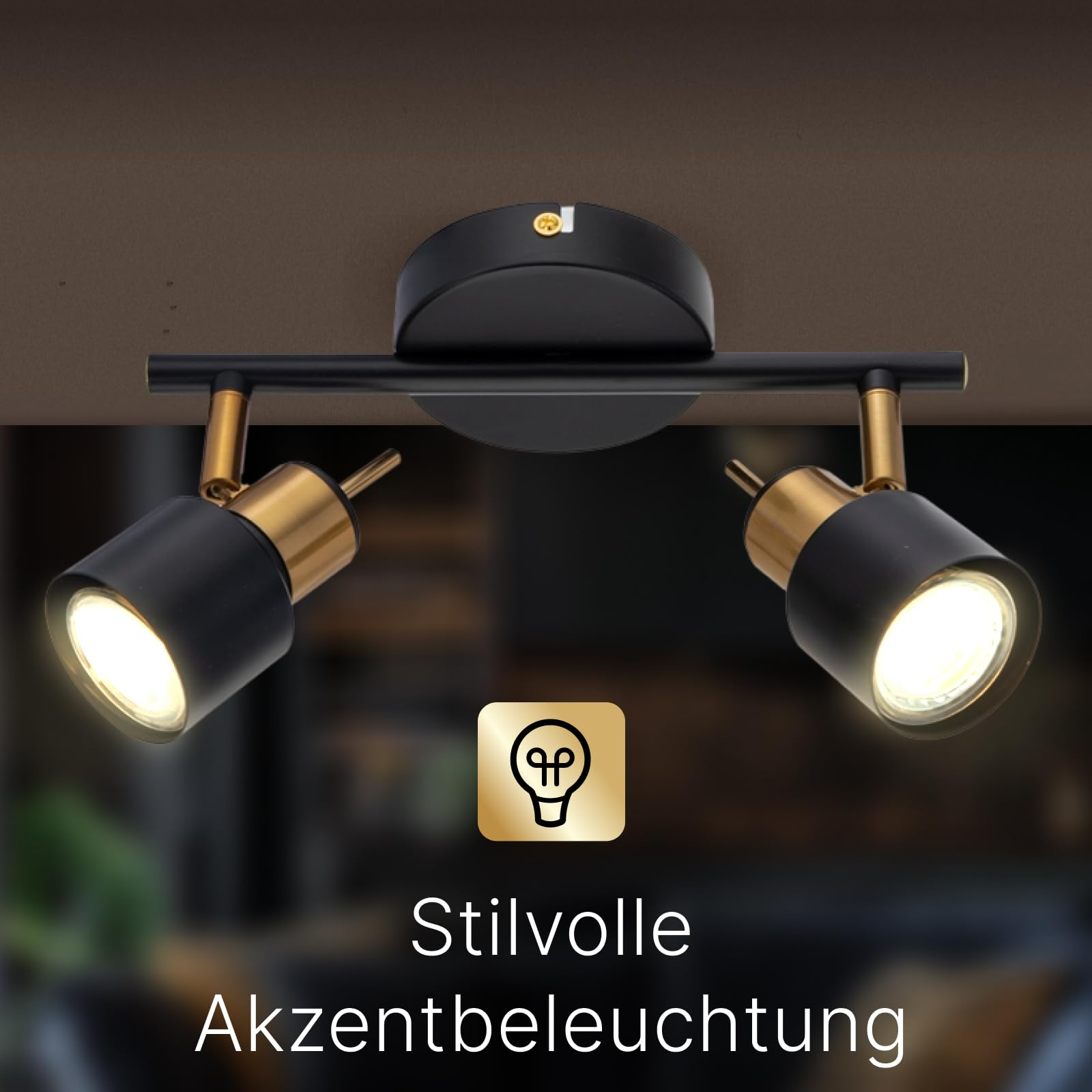 Zwei schwarze und goldene Deckenstrahler mit je einem leuchtenden Leuchtmittel.