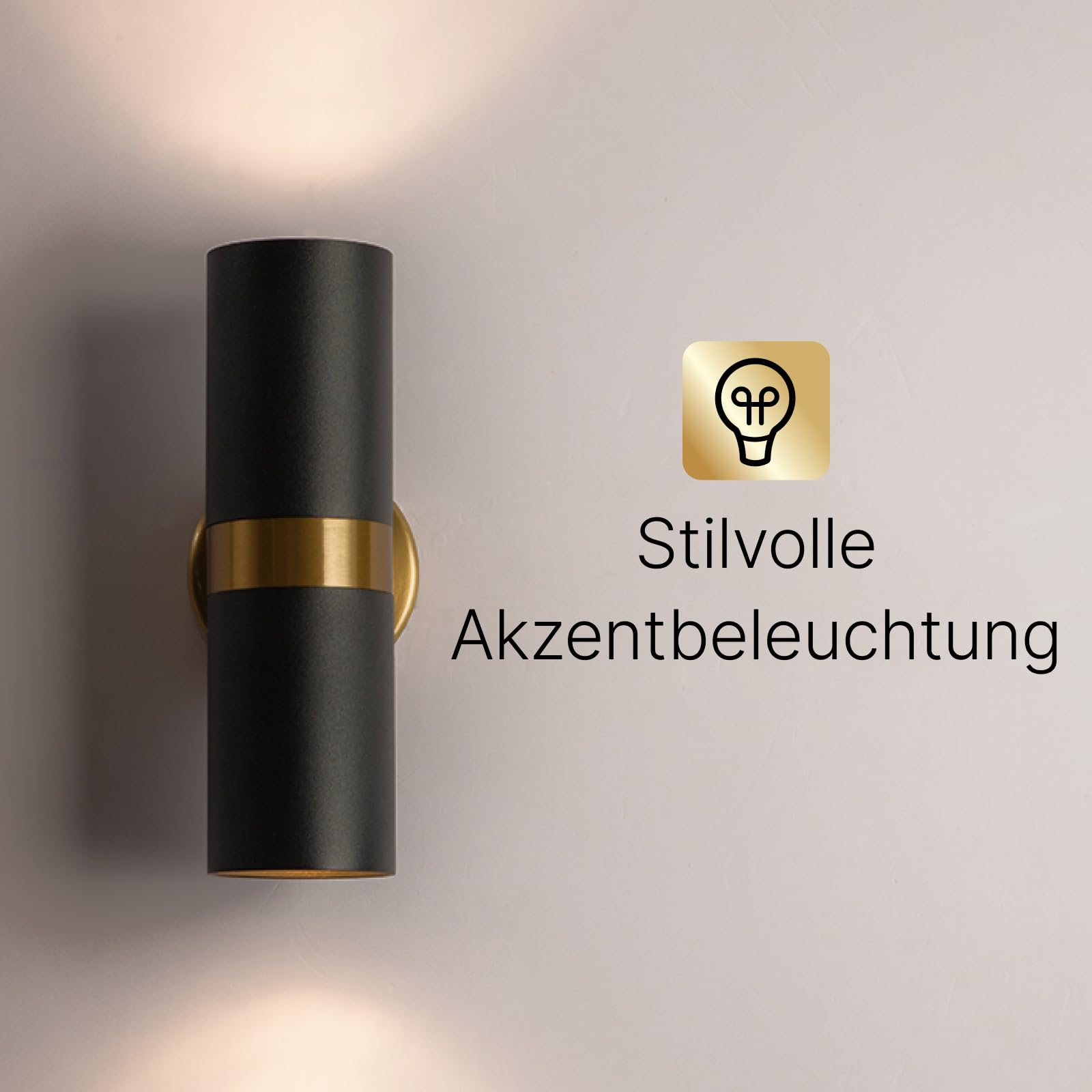 Schwarze Wandleuchte mit goldenem Ring, strahlt Licht nach oben und unten ab.