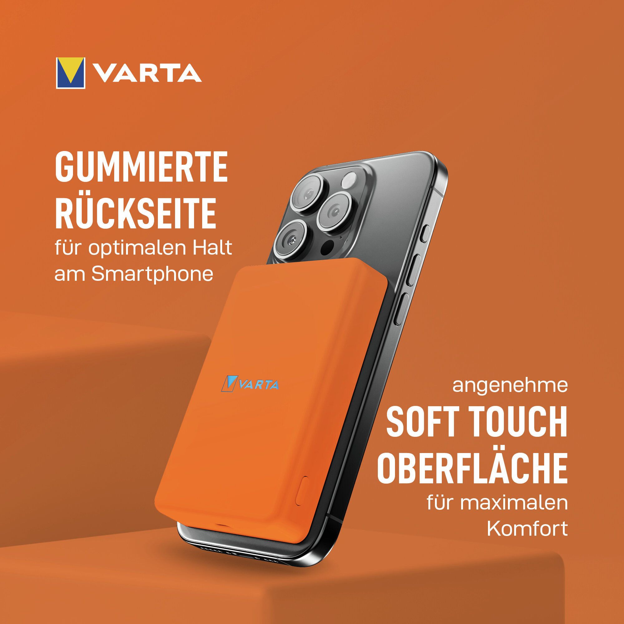 Varta-Logo. Ein Smartphone mit orangener Hülle, die als Gummirückseite beschrieben wird.