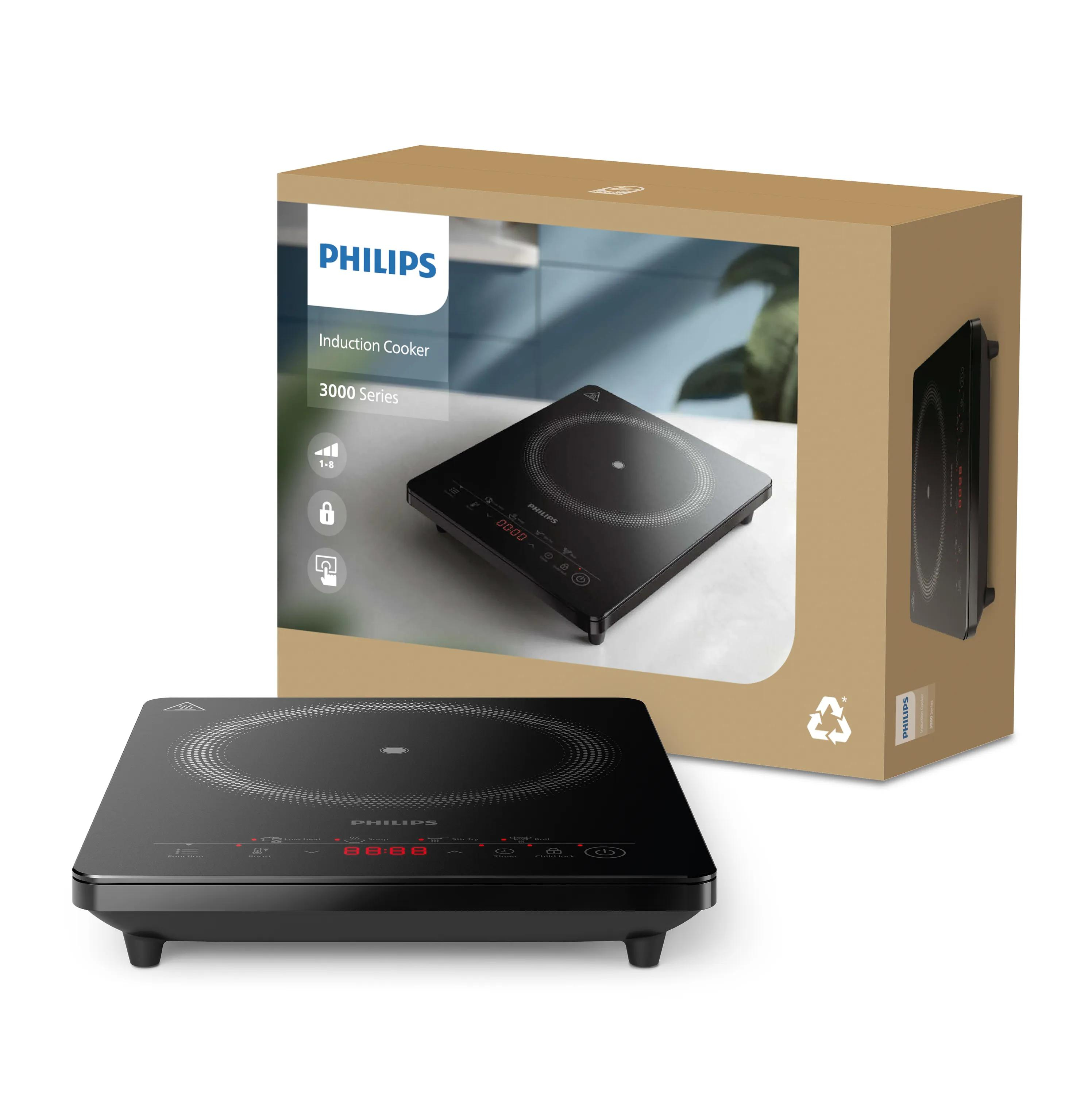 Ein schwarzer Philips Induktionskochfeld steht vor seiner Verpackung.