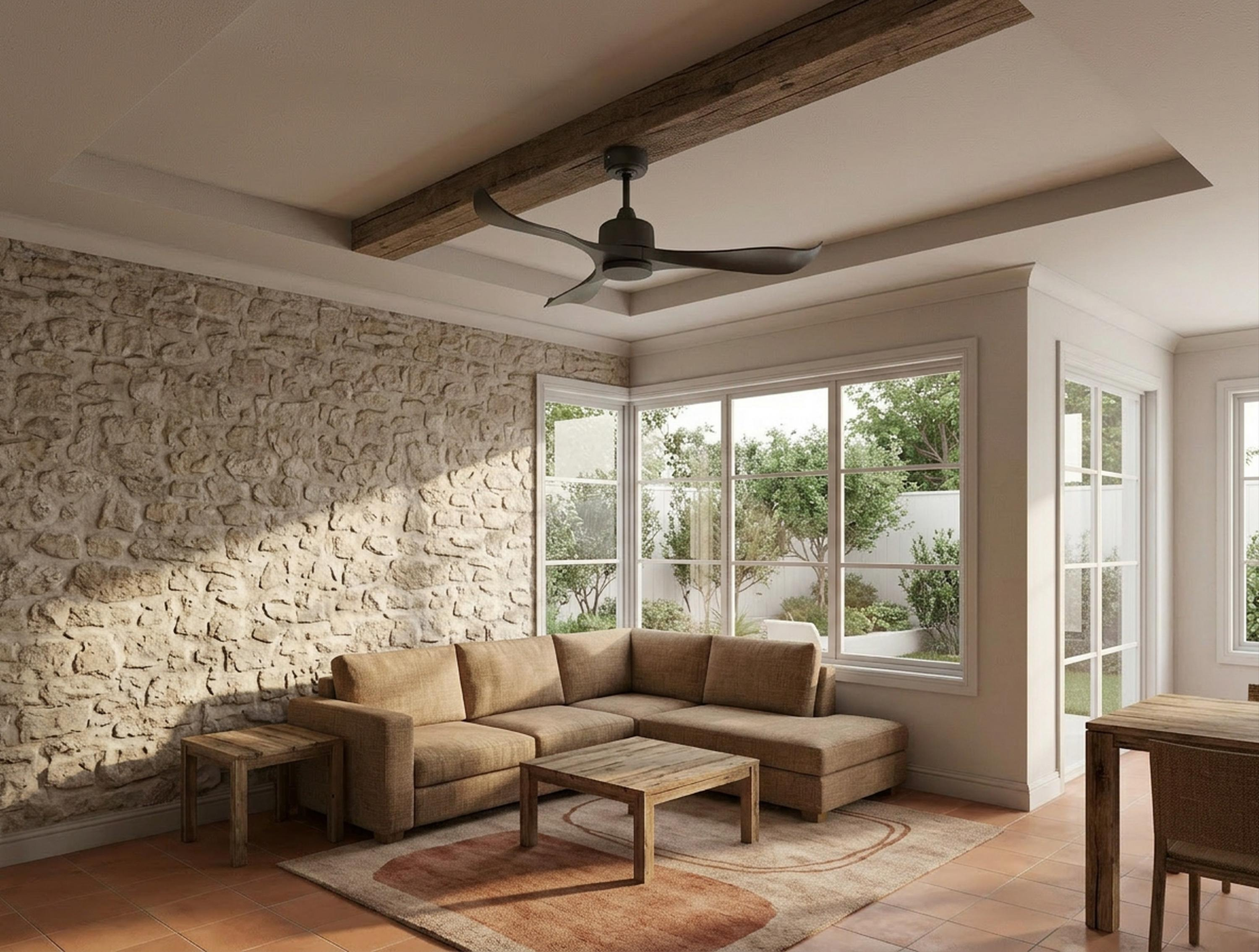 Sala de estar con pared de piedra, sofá, mesa de centro, alfombra y ventilador de techo.