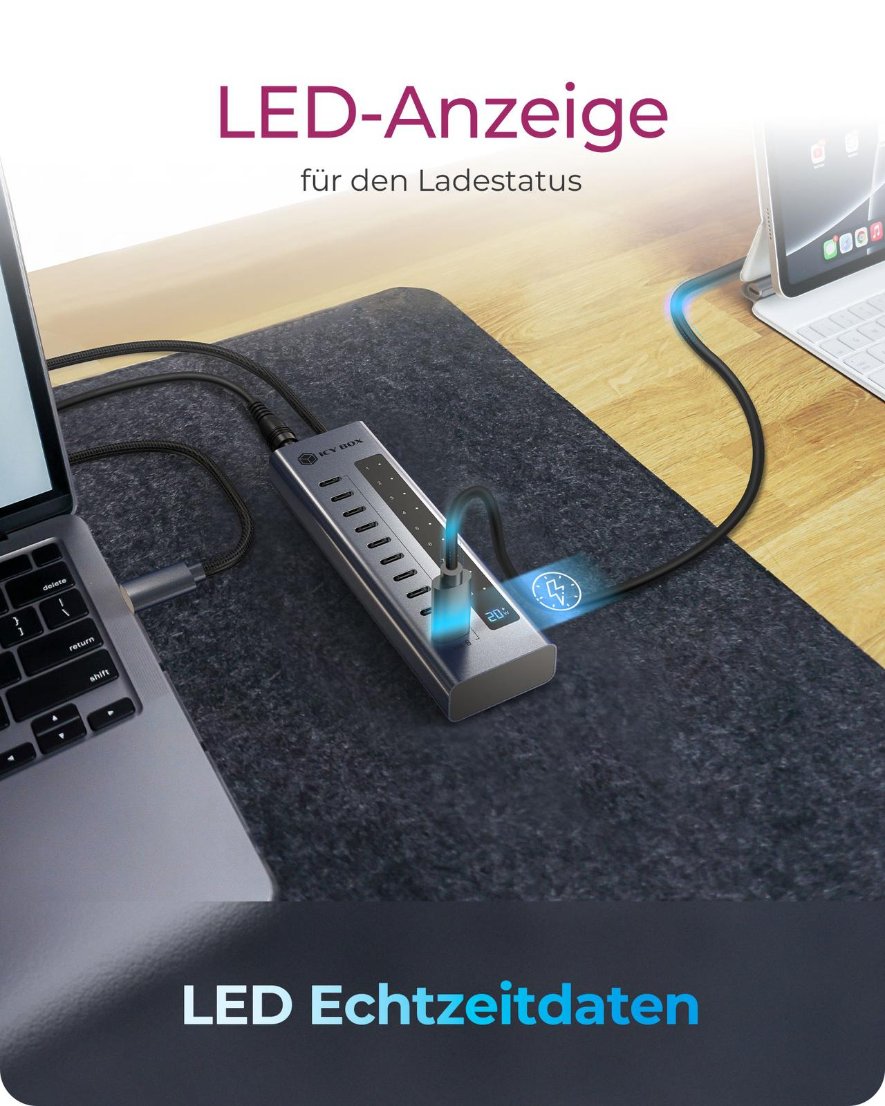 Un hub USB gris avec écran LED, connecté à un ordinateur portable et une tablette.