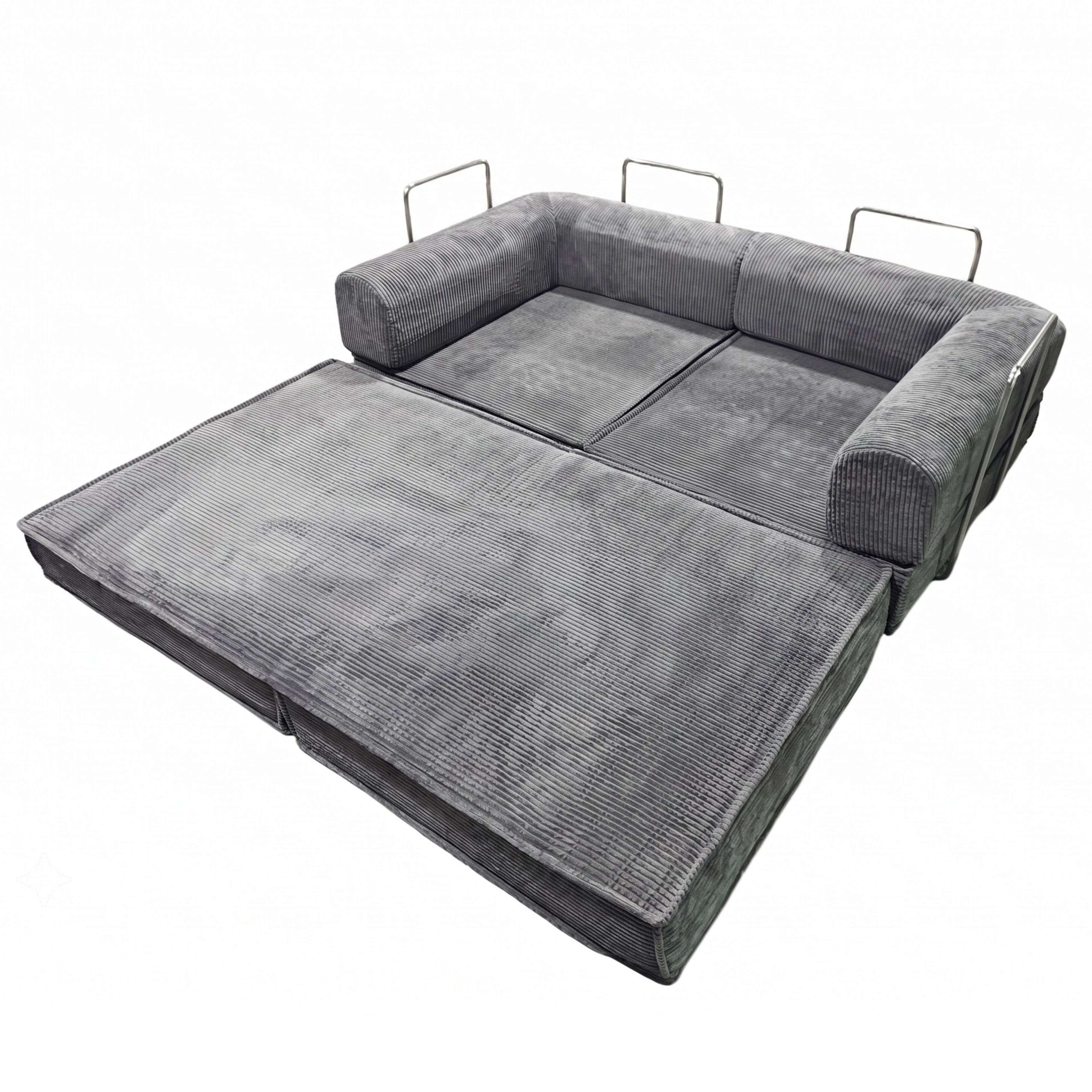 Sofá cama de pana gris, extendido, con asas metálicas en los brazos.