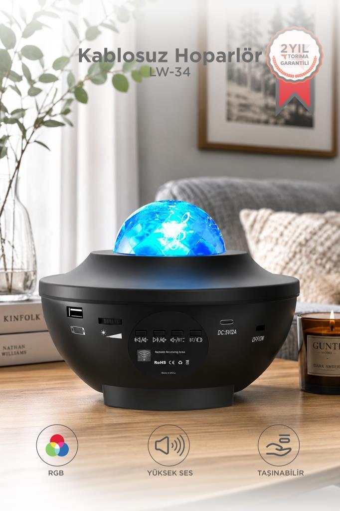 RGB, ses ve taşınabilirlik simgeli, mavi yıldız ışığı projektörlü siyah Bluetooth hoparlör.