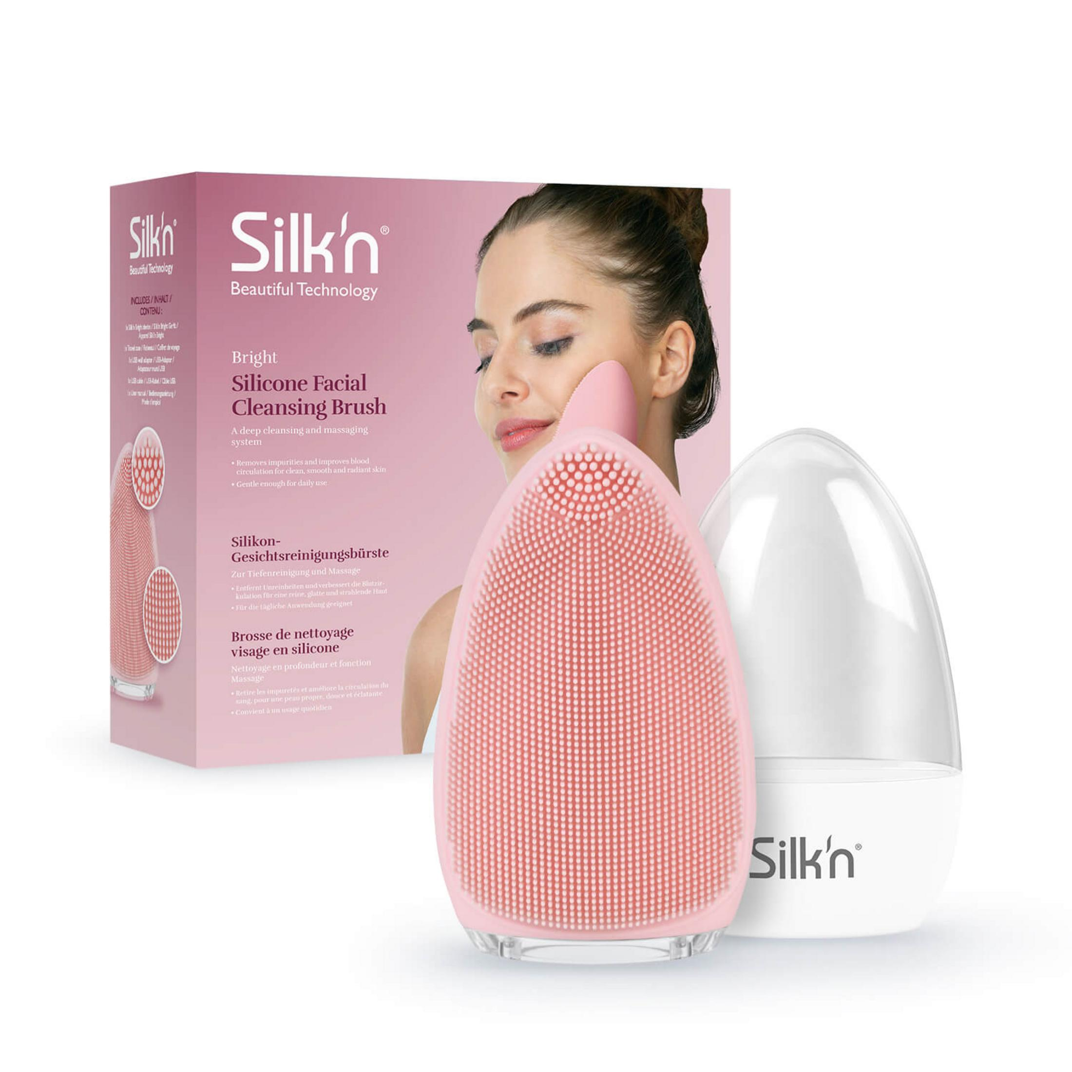Ein rosa Silikon-Gesichtsreinigungsgerät mit Borsten und einem durchsichtigen Deckel.