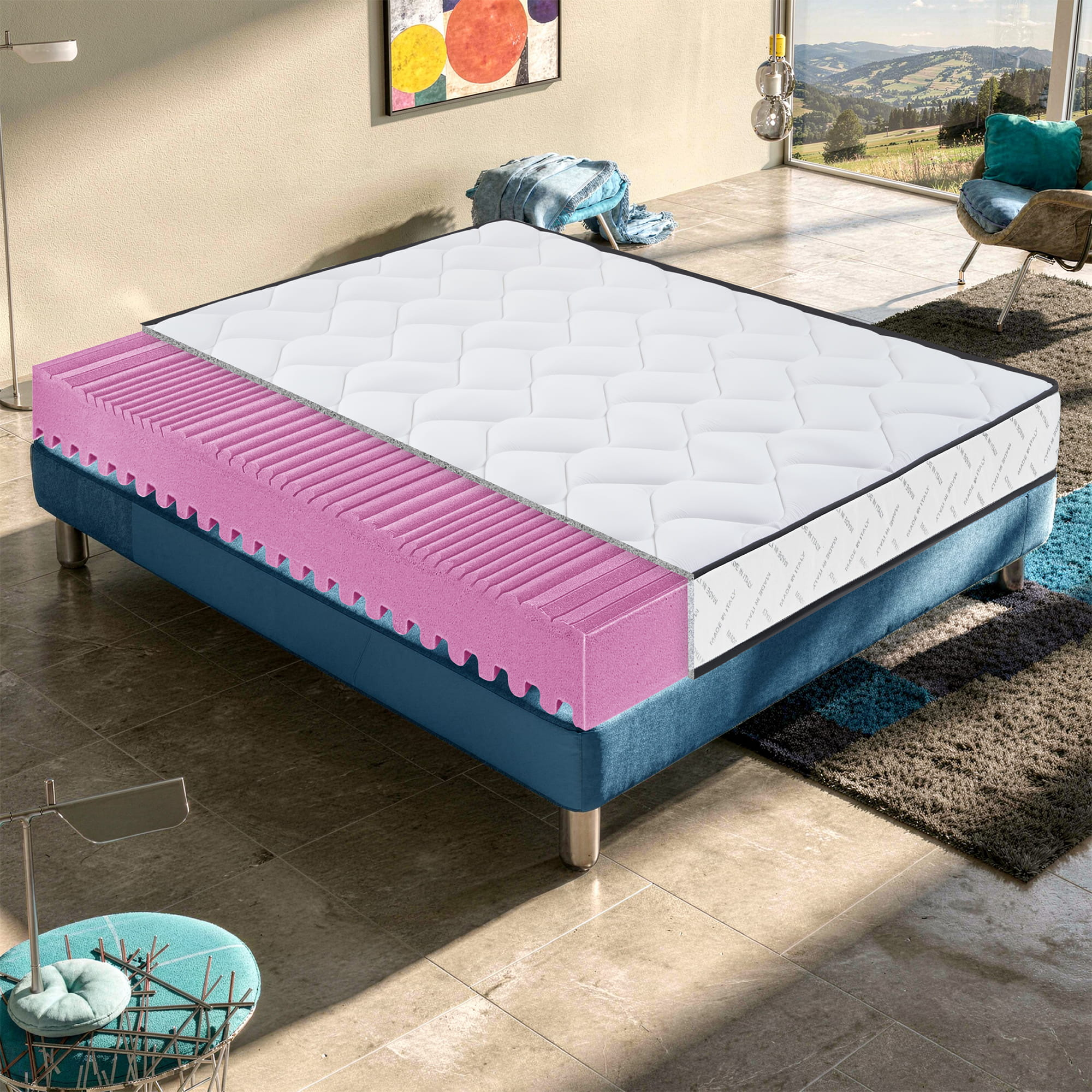 Cama seccionada con base azul y espuma rosa. Ambiente interior moderno.