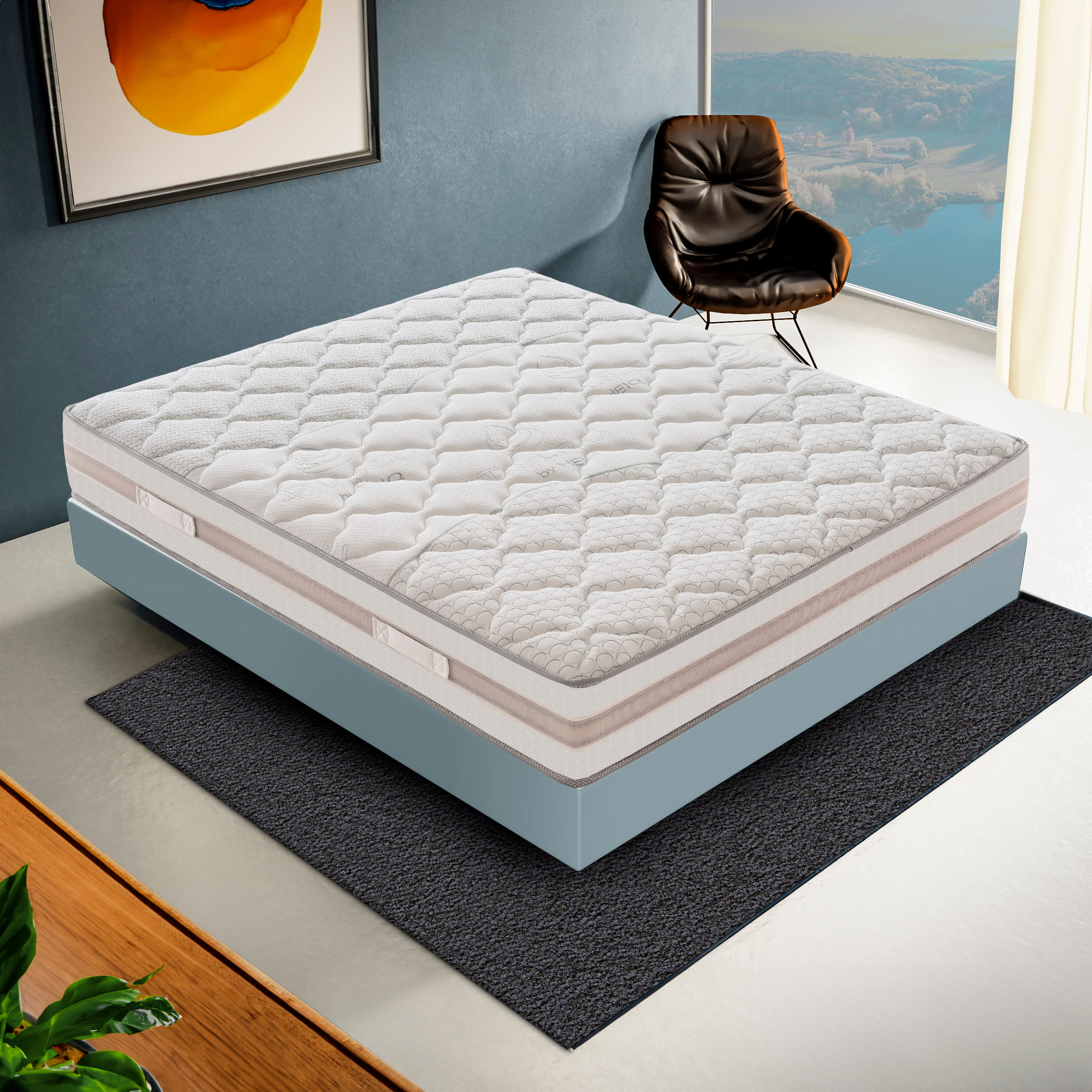 Un colchón blanco sobre un somier azul descansa sobre una alfombra gris en una habitación.