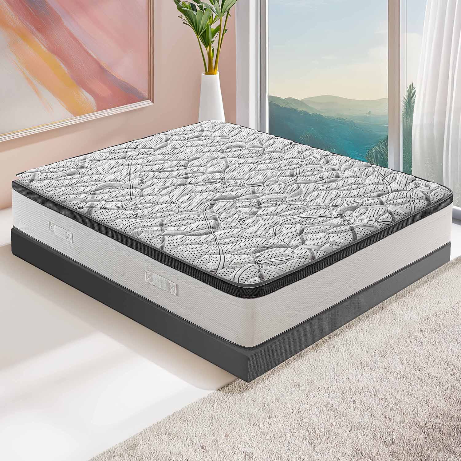 Un colchón blanco y gris con parte superior estampada descansa sobre una base gris oscuro.