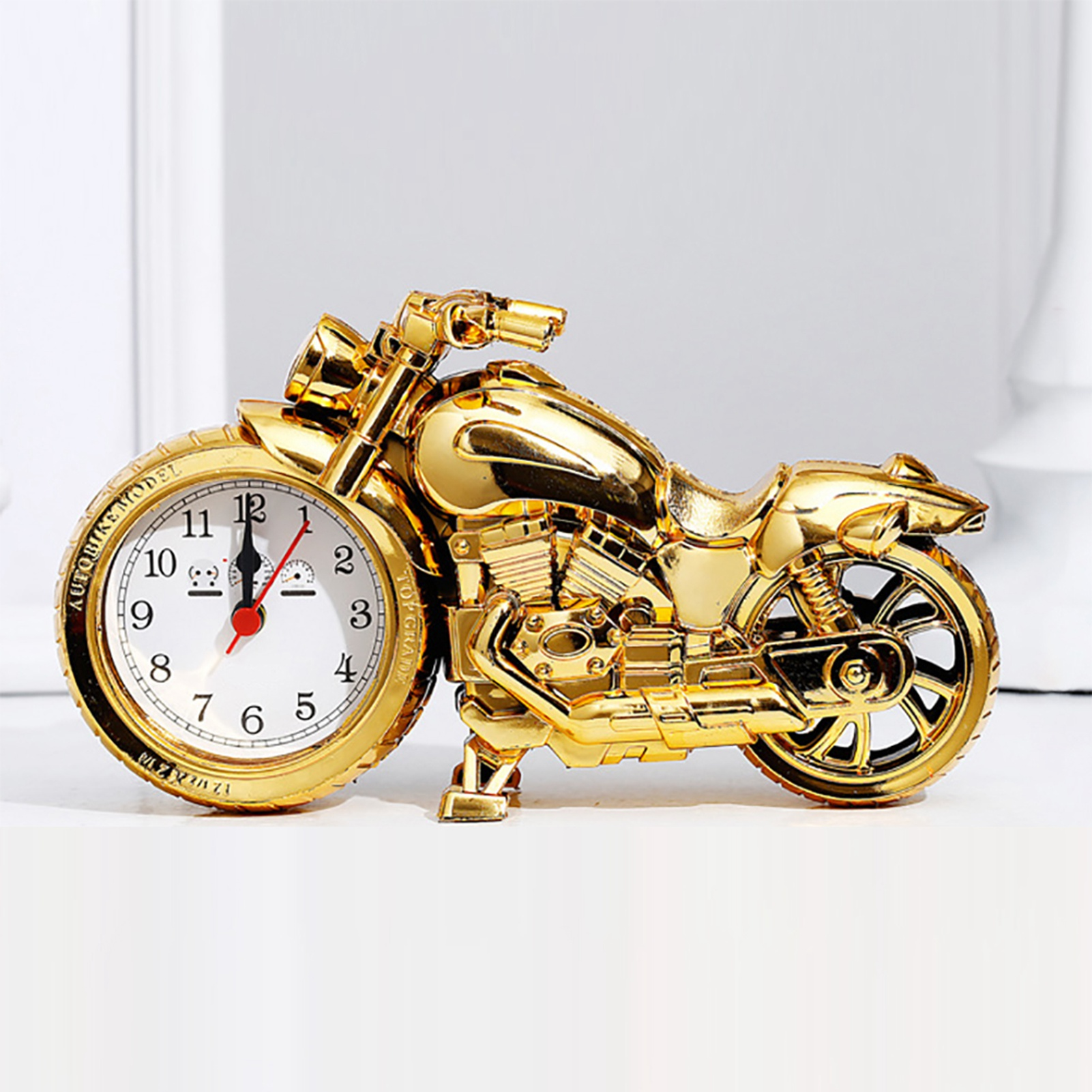 Goldene Motorrad-Uhr mit weißem Zifferblatt und roten Zeigern, detaillierte Nachbildung.