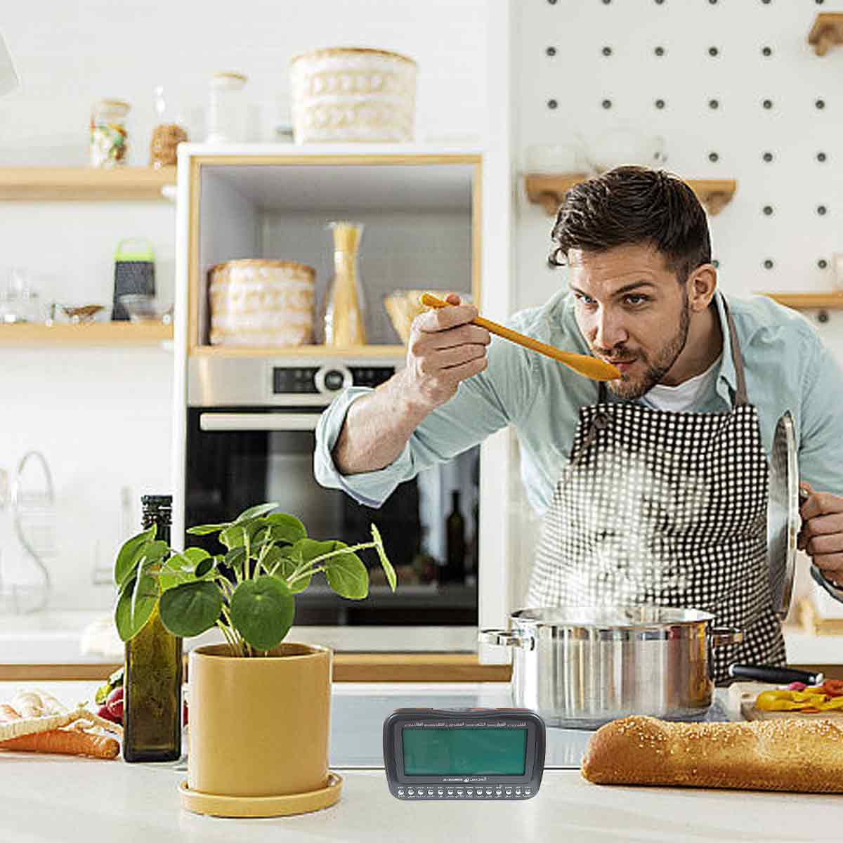 Mann in Schürze kostet Essen vom Löffel, dampfender Topf, Brot auf Arbeitsplatte.