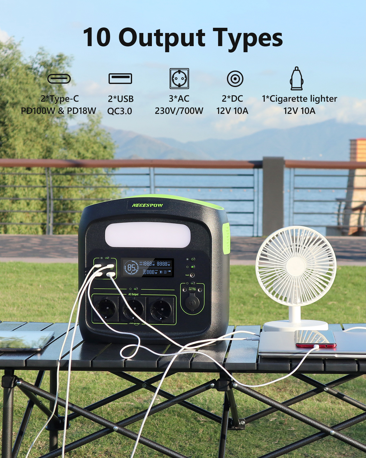 Una central eléctrica portátil con múltiples salidas está sobre una mesa exterior.
