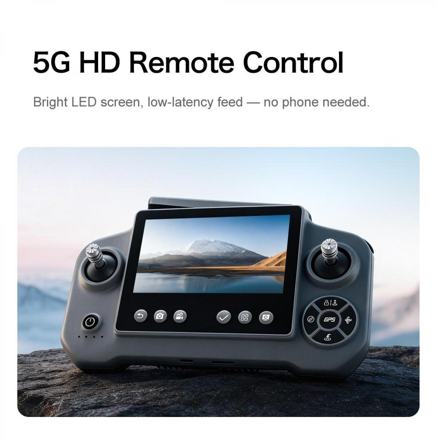 Grauer Drohnen-Controller mit Bildschirm, der eine Berglandschaft zeigt.