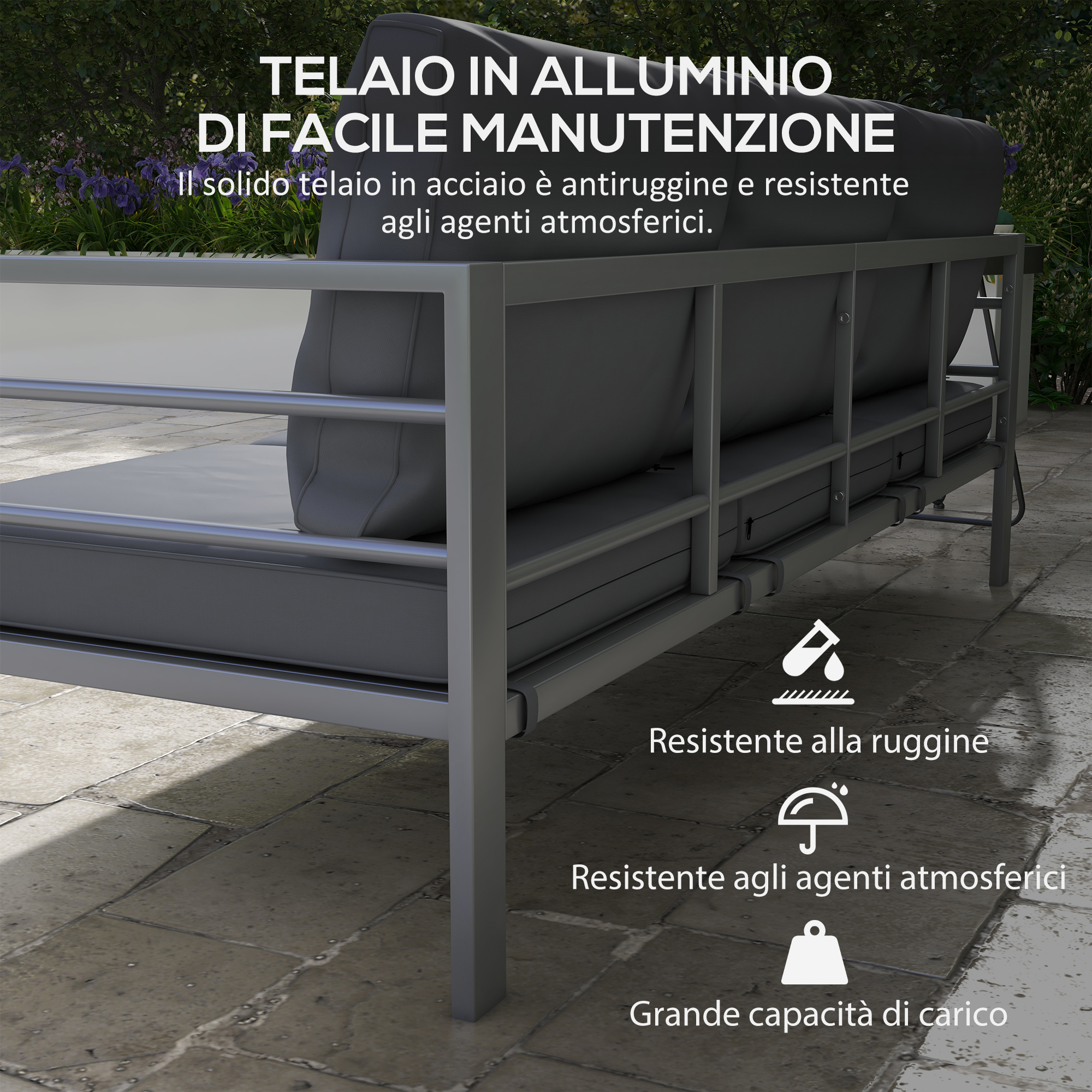 Un divano in alluminio grigio con cuscini si trova su un patio di pietra.