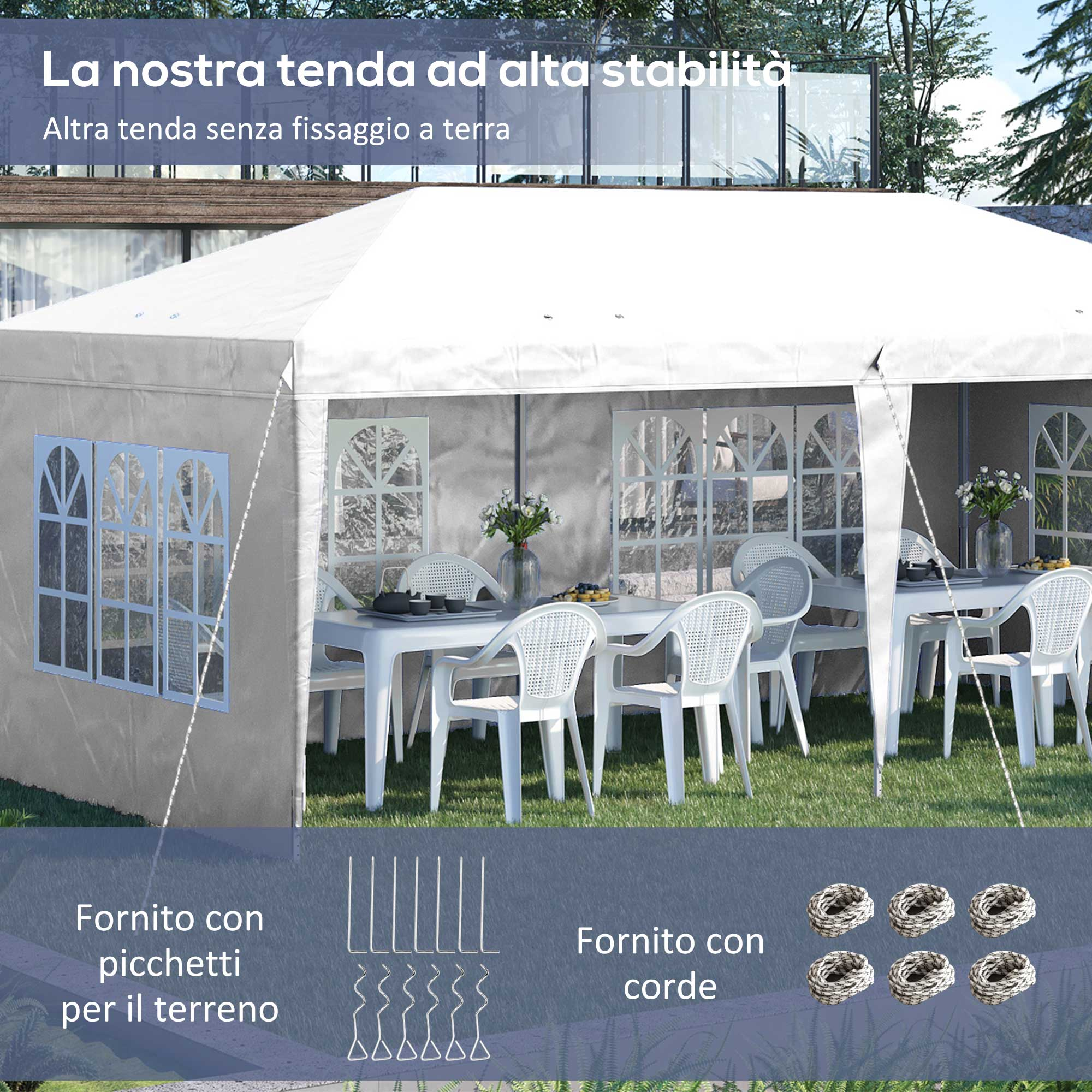Una tenda bianca con tavoli e sedie sull'erba, con accessori sotto.