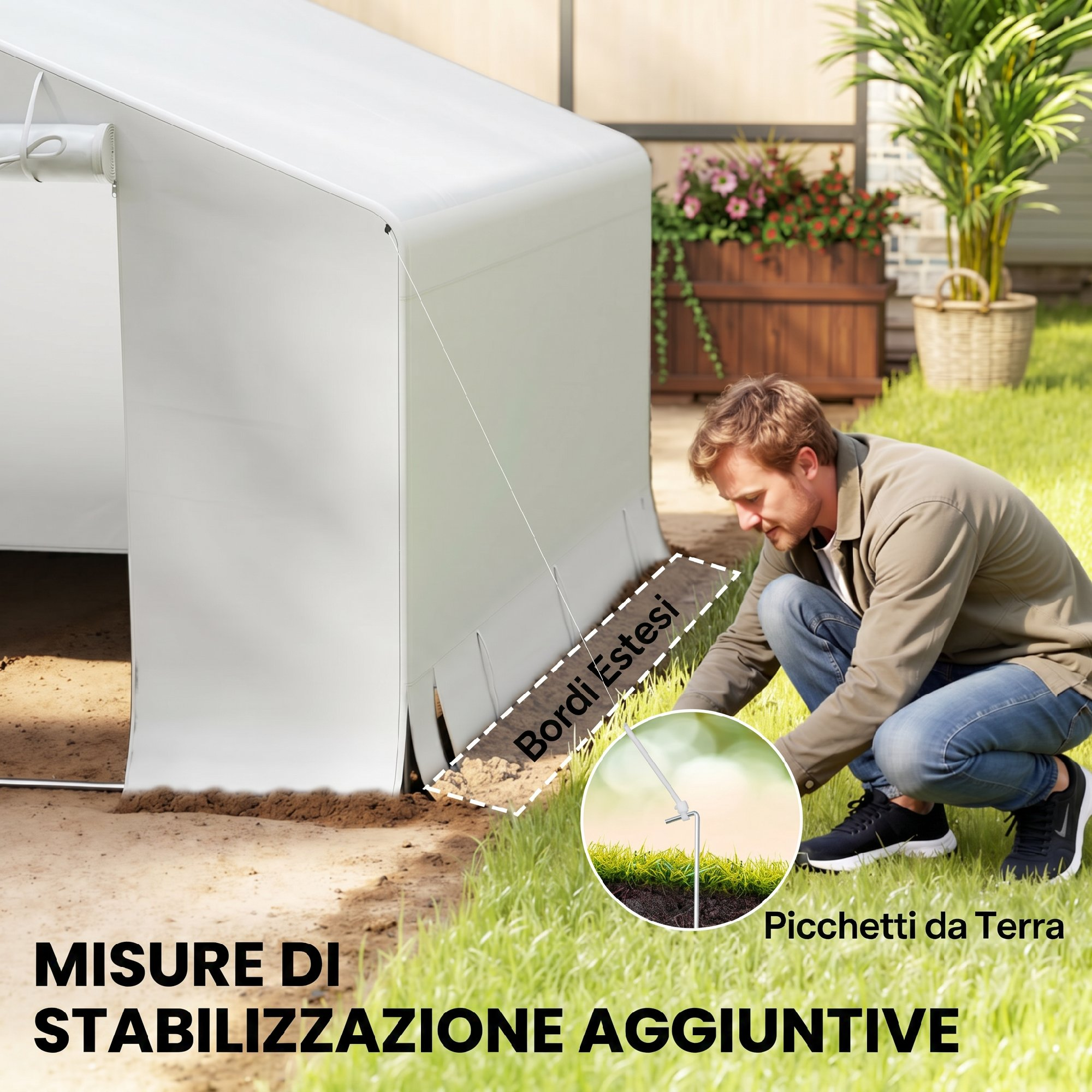 Uomo fissa tenda bianca con picchetti nel prato. Misura di stabilizzazione aggiuntiva.