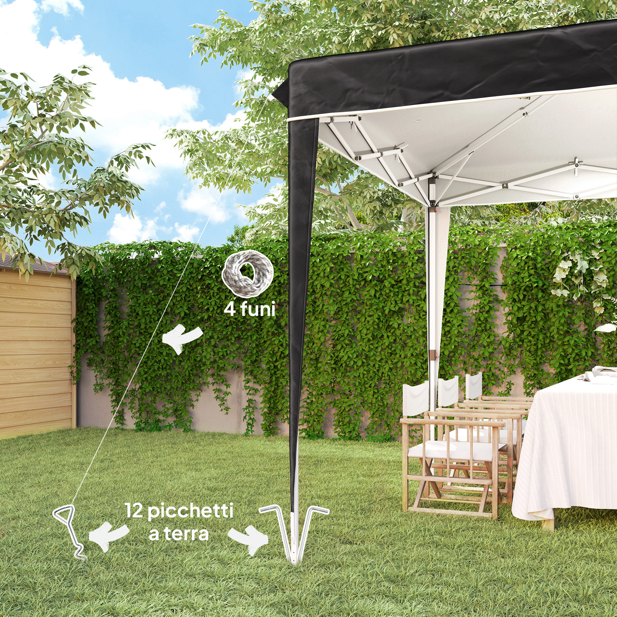 Un gazebo con tavoli e sedie in giardino, fissato con corde e picchetti.