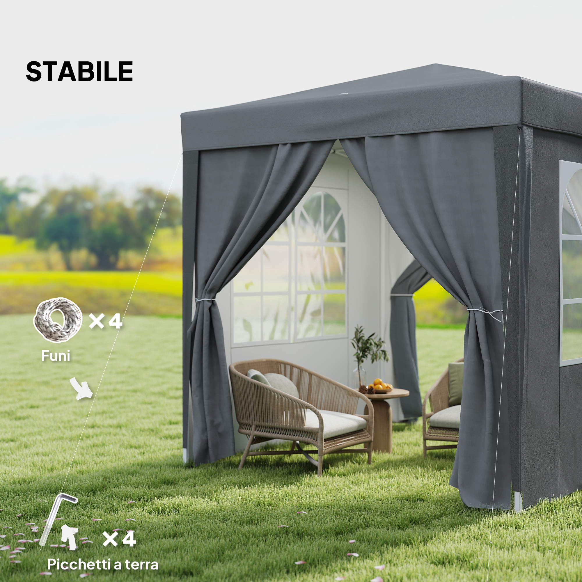 Gazebo grigio esterno con mobili, corde e picchetti sull'erba.