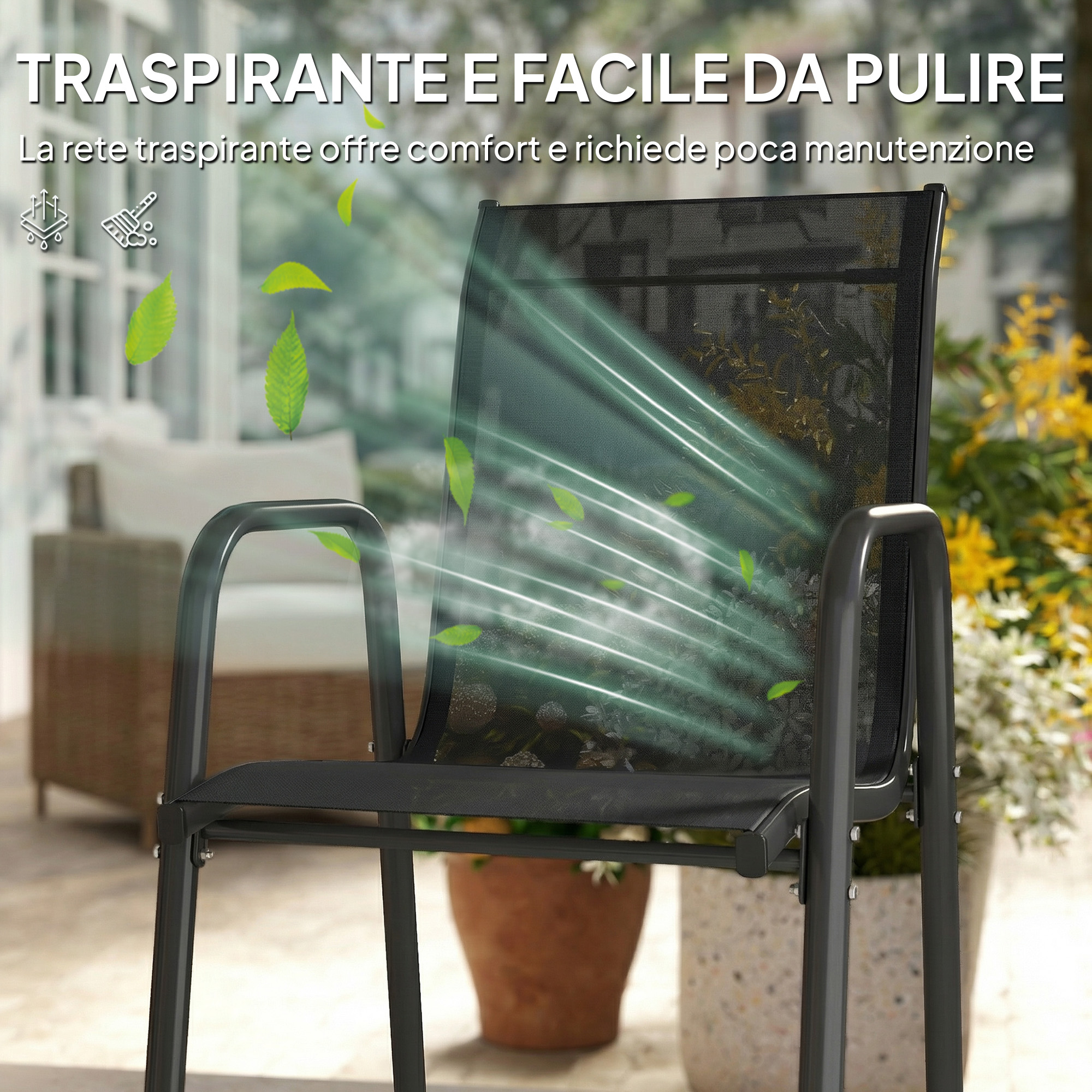 Una sedia nera con schienale in rete all'aperto, circondata da foglie e fiori.