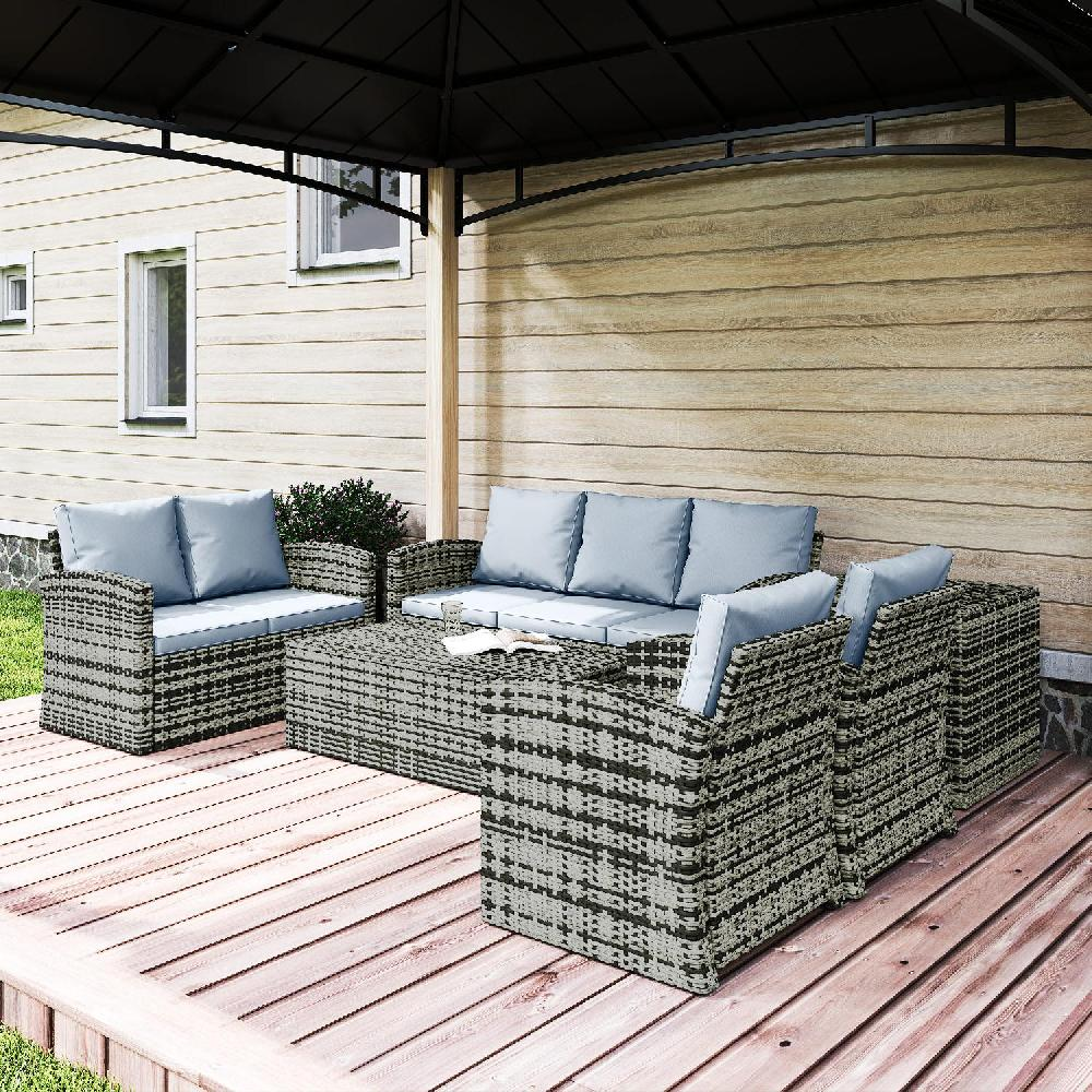 Set da giardino in vimini con cuscini azzurri sotto una tettoia su un ponte di legno.