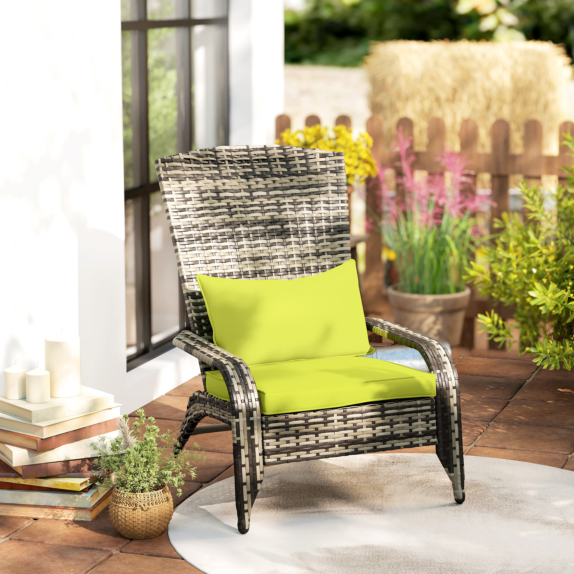 Sedia in vimini con cuscini verde brillante su un patio con libri e piante.