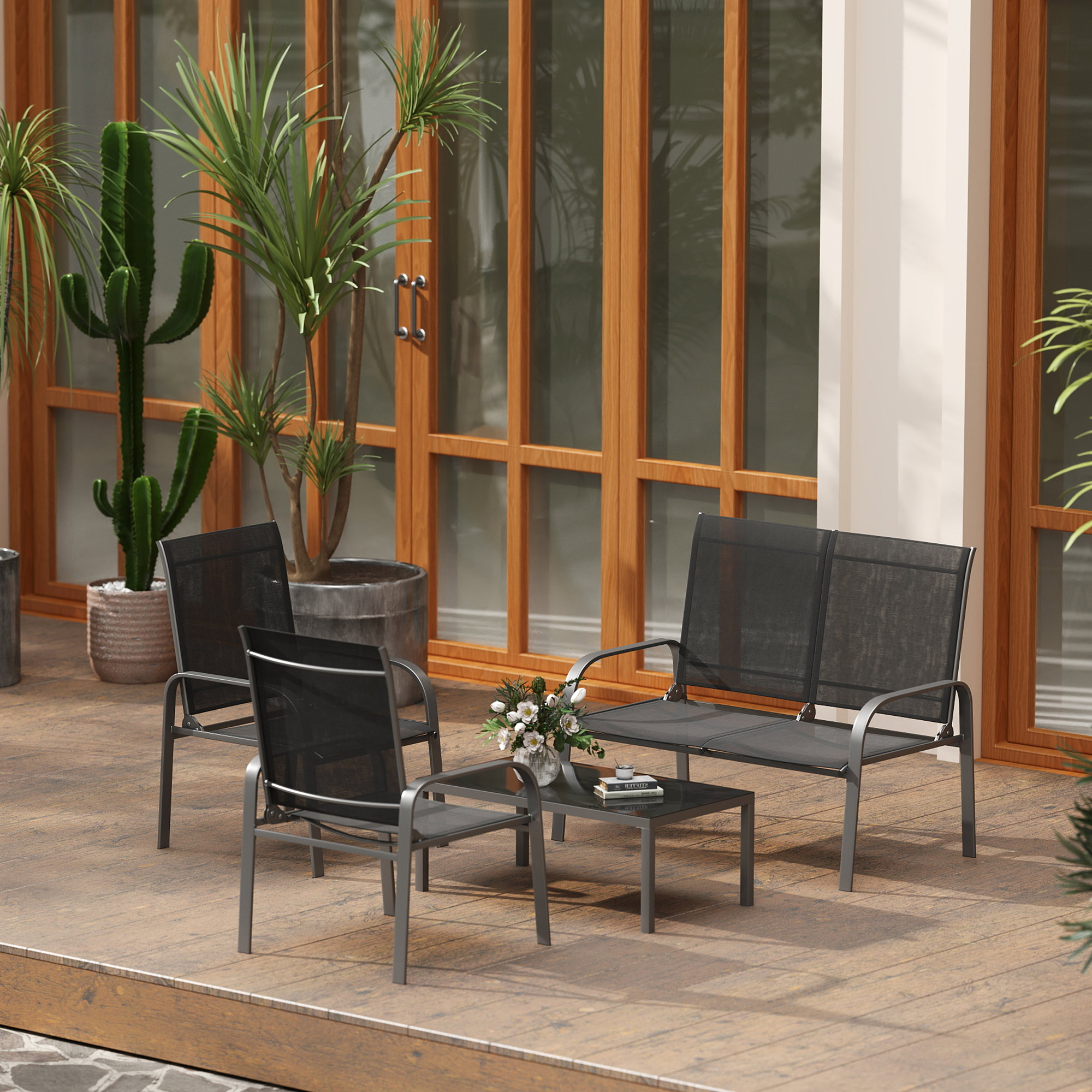Arredamento da giardino grigio scuro con tavolo, piante e porte in legno.