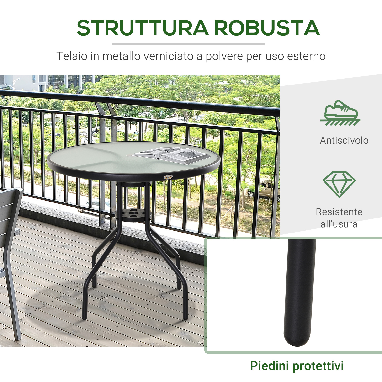 Tavolo rotondo in vetro con struttura in metallo nero su balcone in legno.