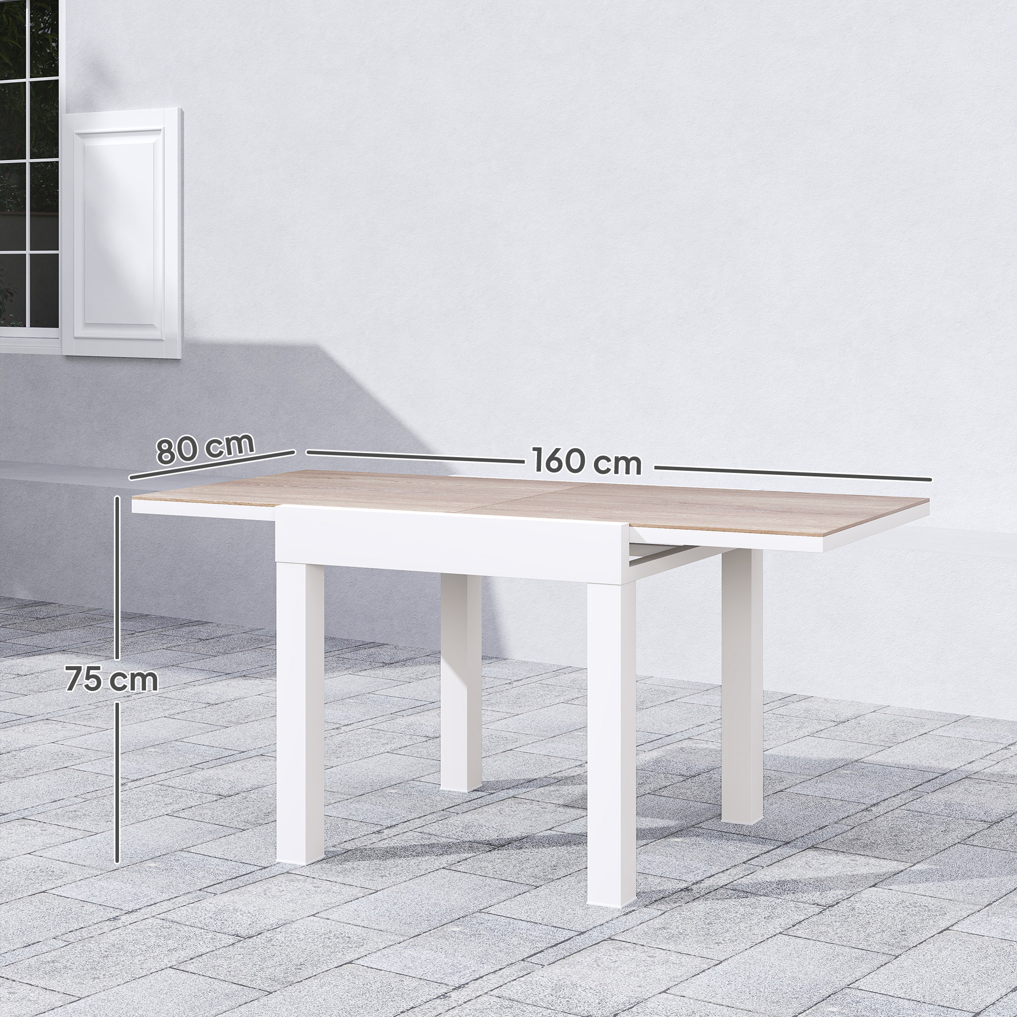Un tavolo allungabile con struttura bianca e piano in legno si trova su un pavimento pavimentato.