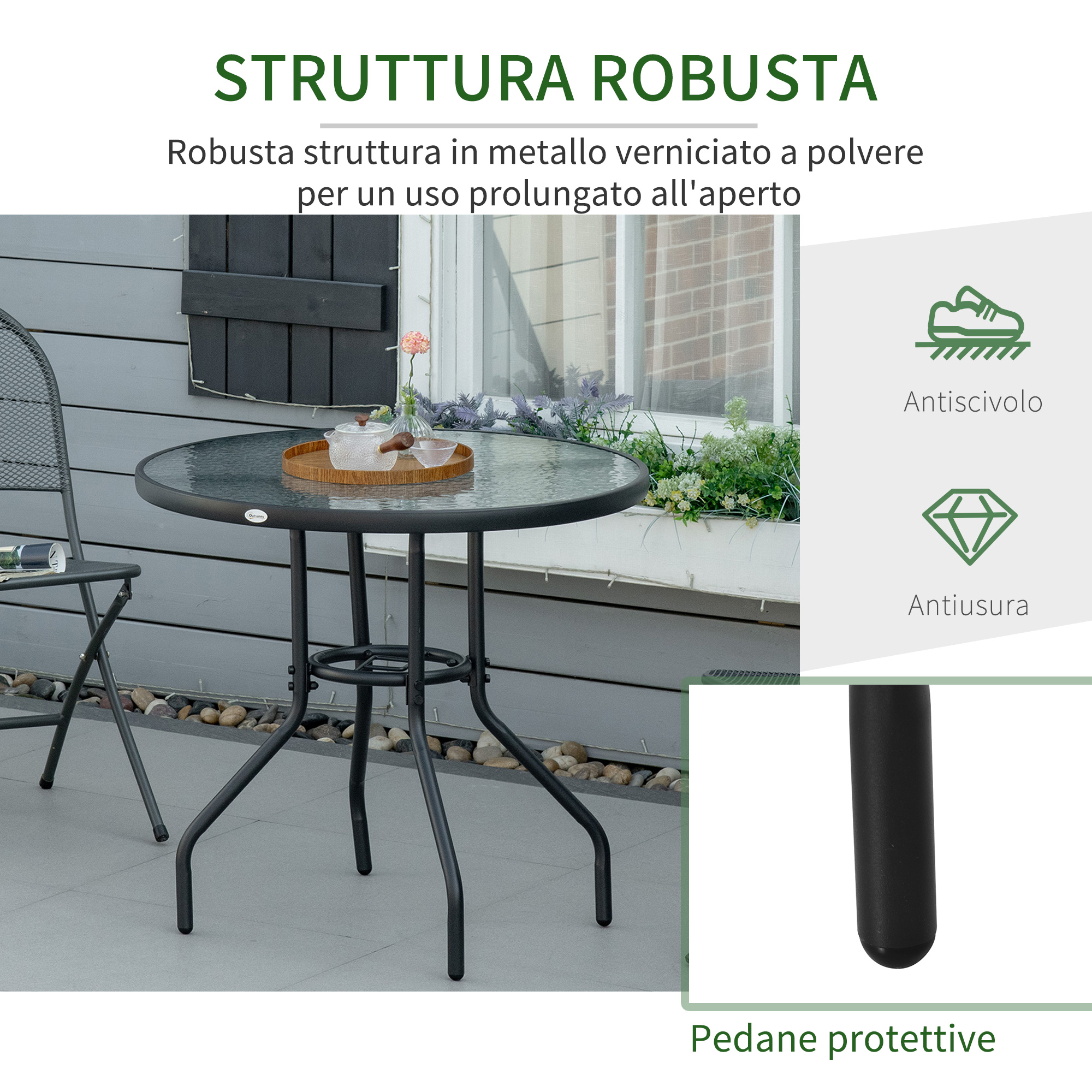 Un tavolo rotondo in vetro con struttura in metallo e una sedia su un patio.