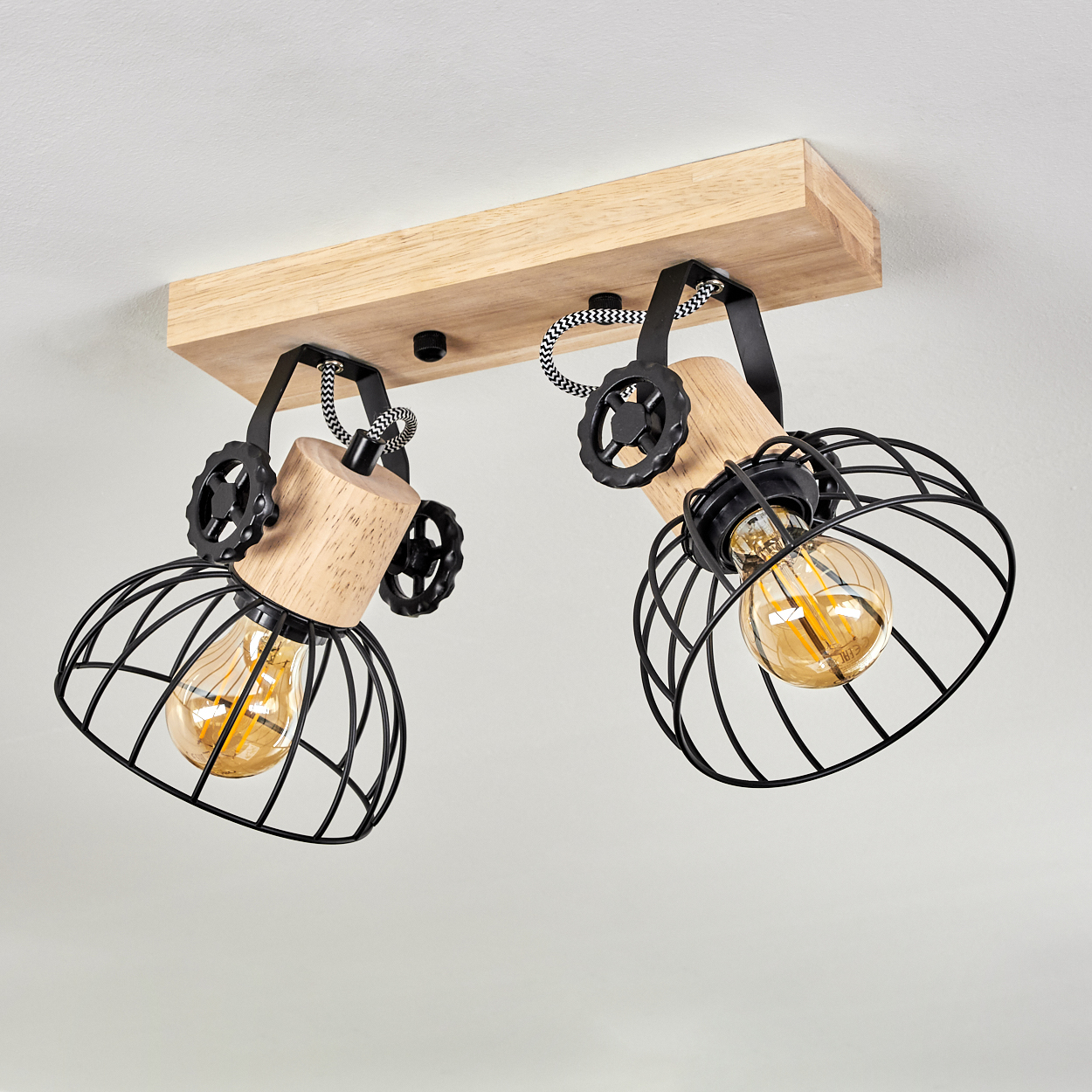 Zwei Lampen mit Holzbalkenmontage, schwarzen Drahtkörben und Glühbirnen.