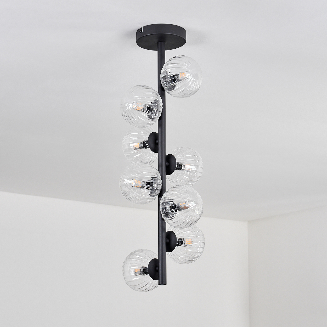 Eine schwarze Lampe mit acht kugelförmigen Glaskolben, die spiralförmig angeordnet sind.