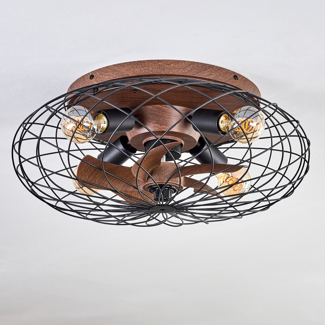 Ein rustikaler Deckenventilator mit schwarzem Metallkäfig, Holzakzenten und vier Edison-Glühbirnen.