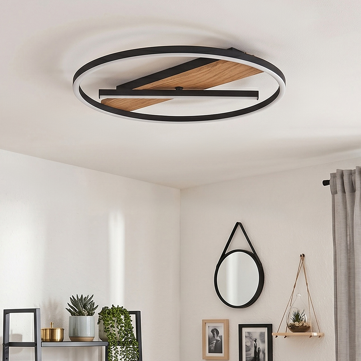 Moderne Deckenleuchte mit schwarzem Ring, Holzdetail und LED-Streifen.