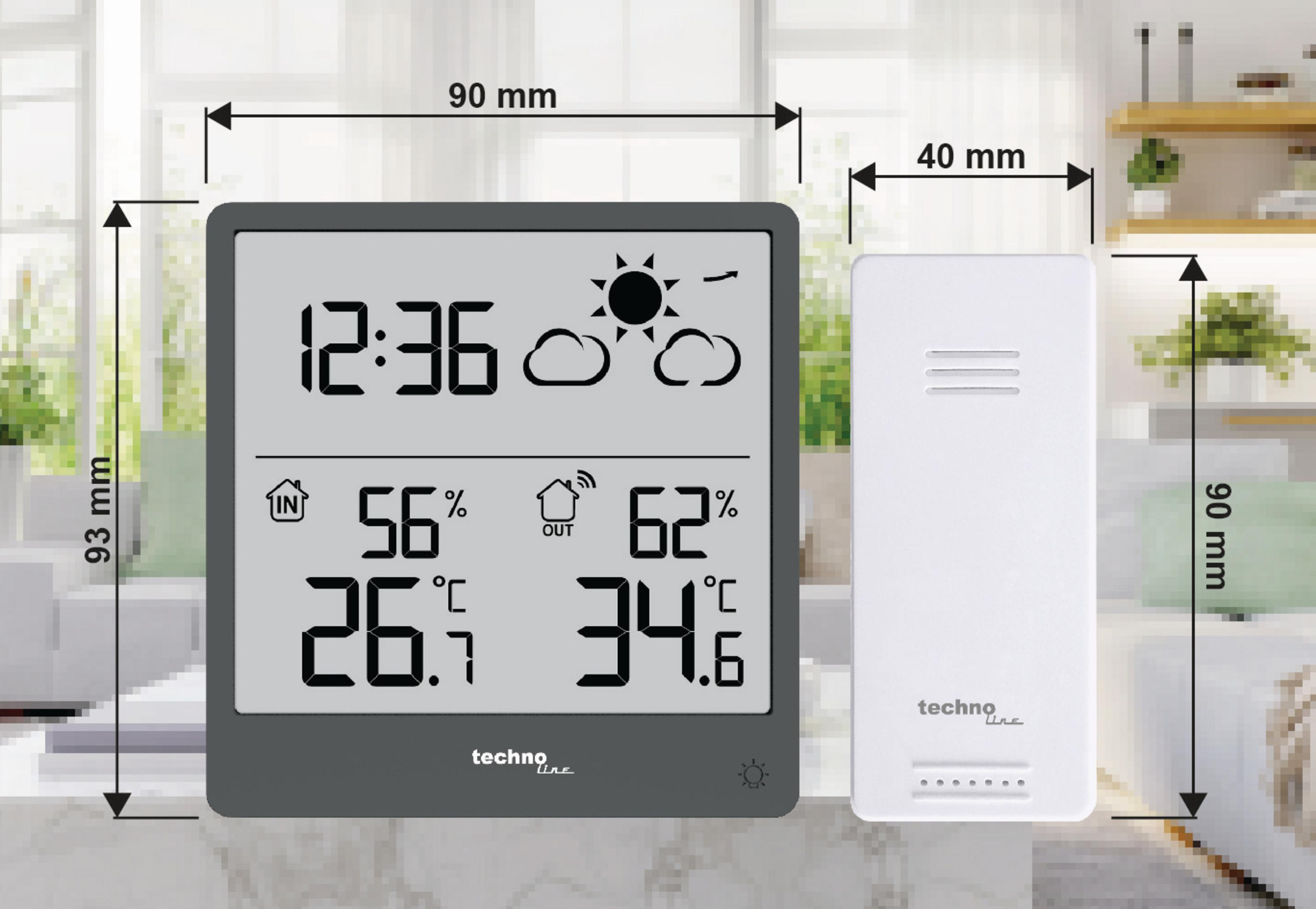 Un thermomètre numérique gris affiche 12:36, 56% int, 26.5°C int, 62% ext, 34.6°C ext.