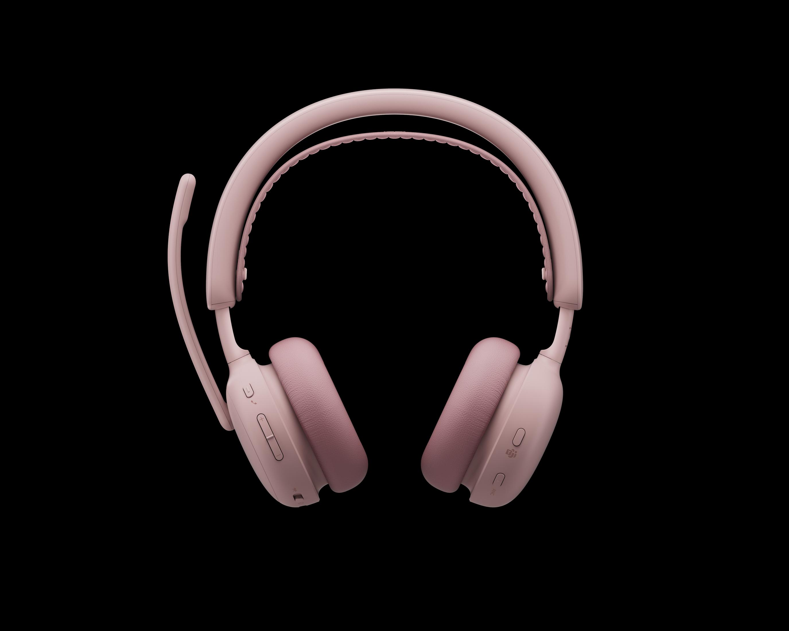 Un paio di cuffie rosa over-ear con microfono e controlli su sfondo nero.