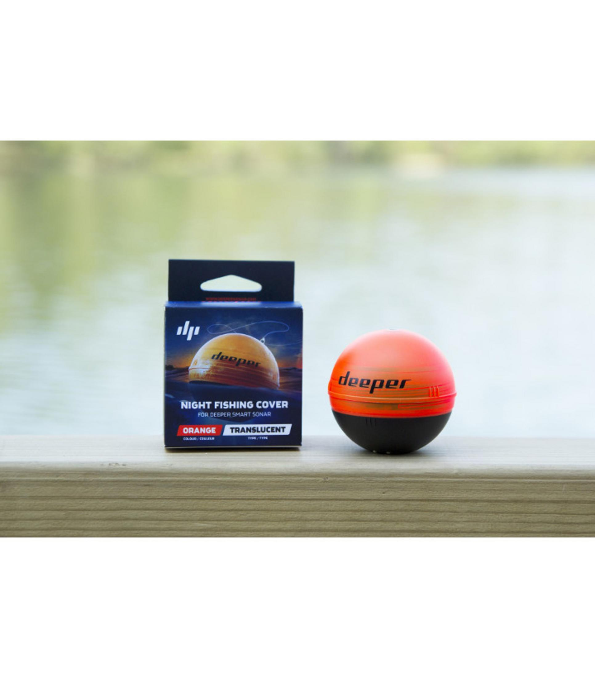 Eine orange-schwarze Angelsonde neben ihrer Verpackung auf Holz.