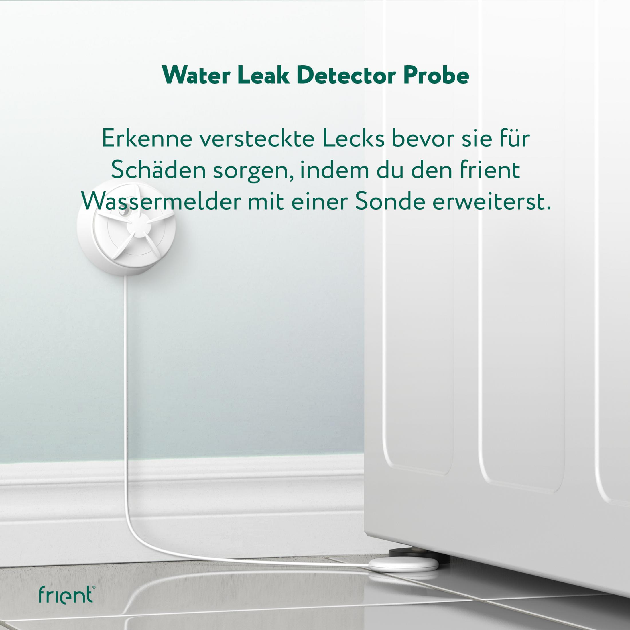 Ein weißer Wasserleckdetektor mit Kabel neben einer Waschmaschine.