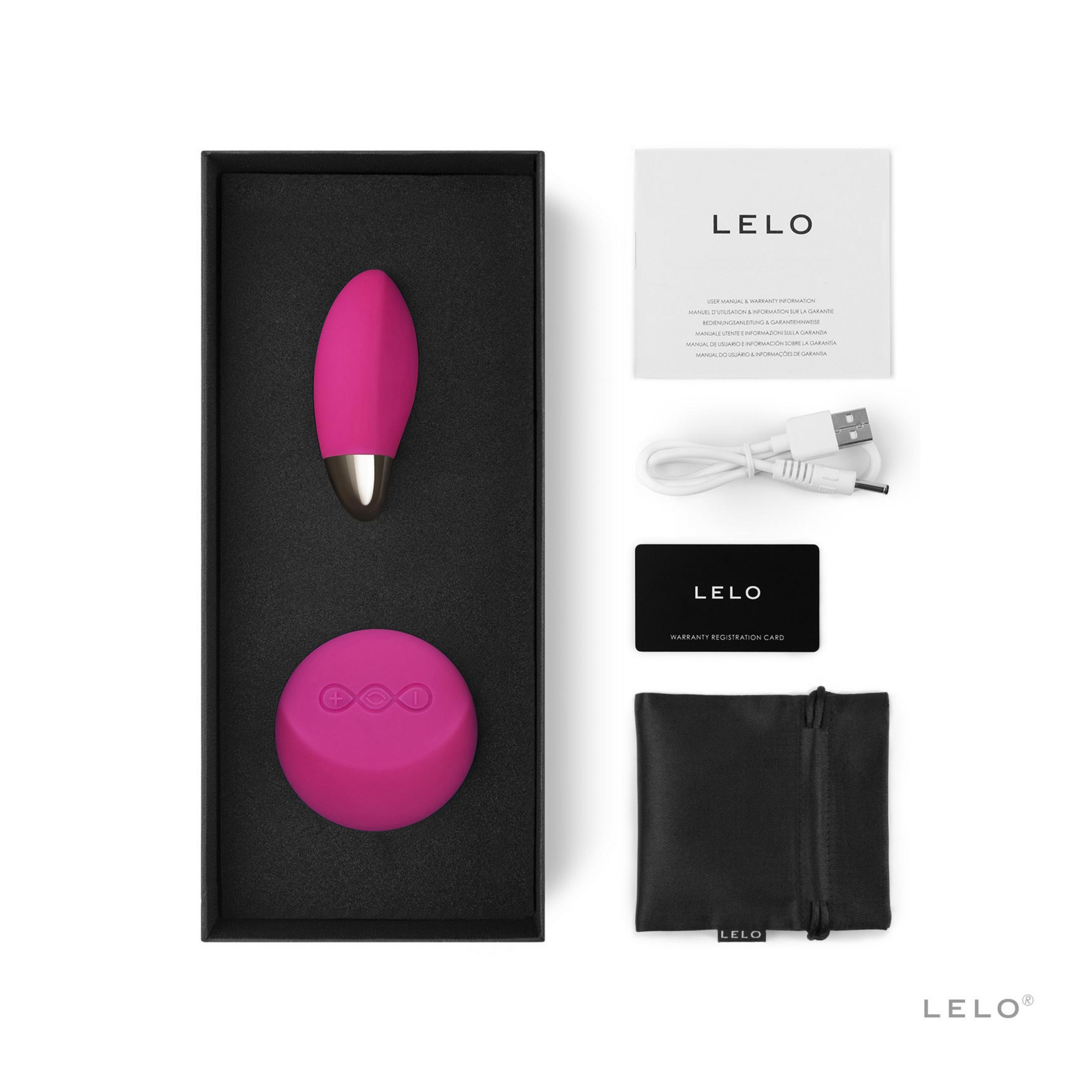 Vibrador y masajeador LELO rosa con cable de carga y manuales en una caja.