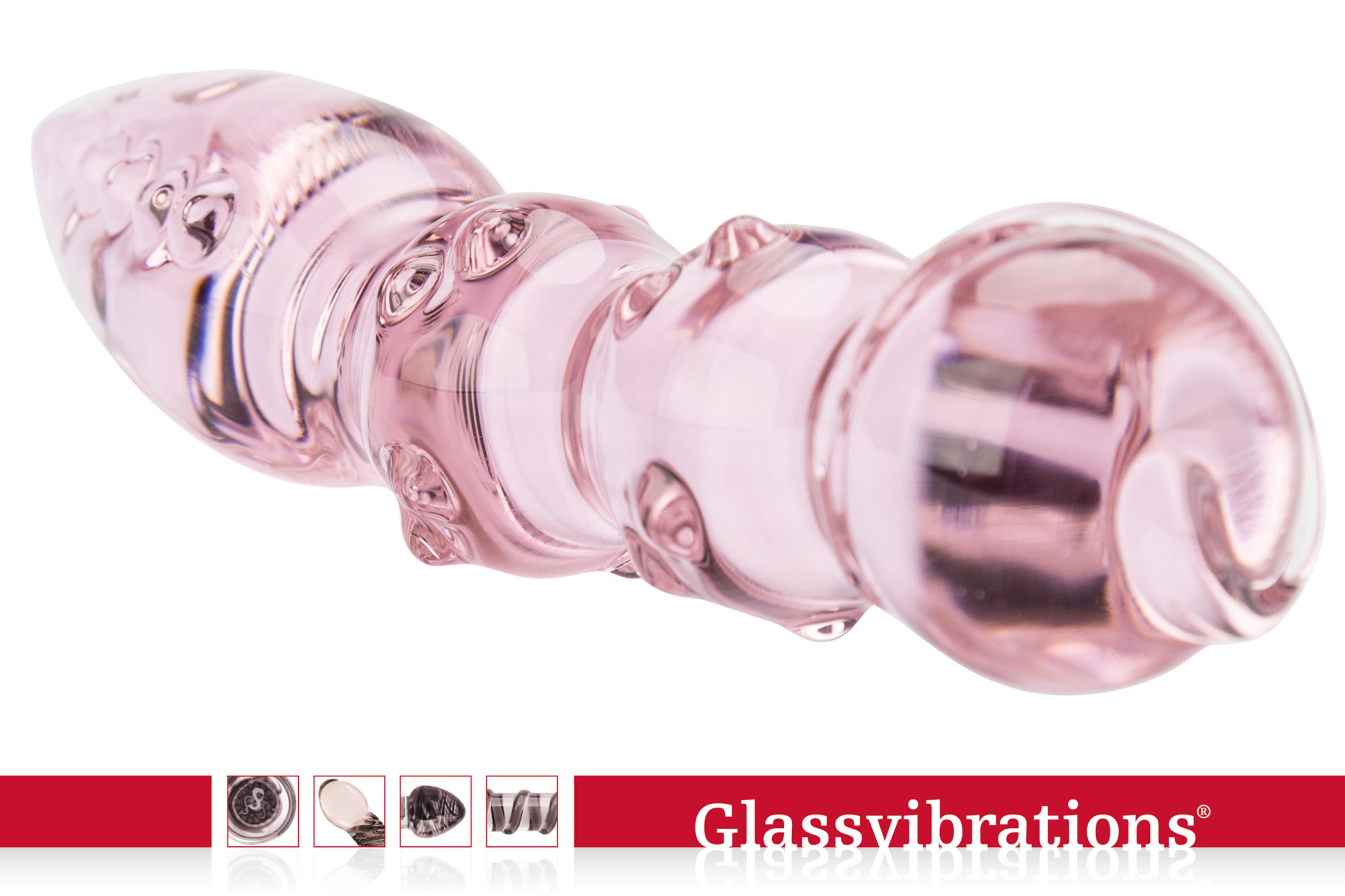 Ein rosafarbener Glas-Dildo mit Noppen und einer geschwungenen Form.