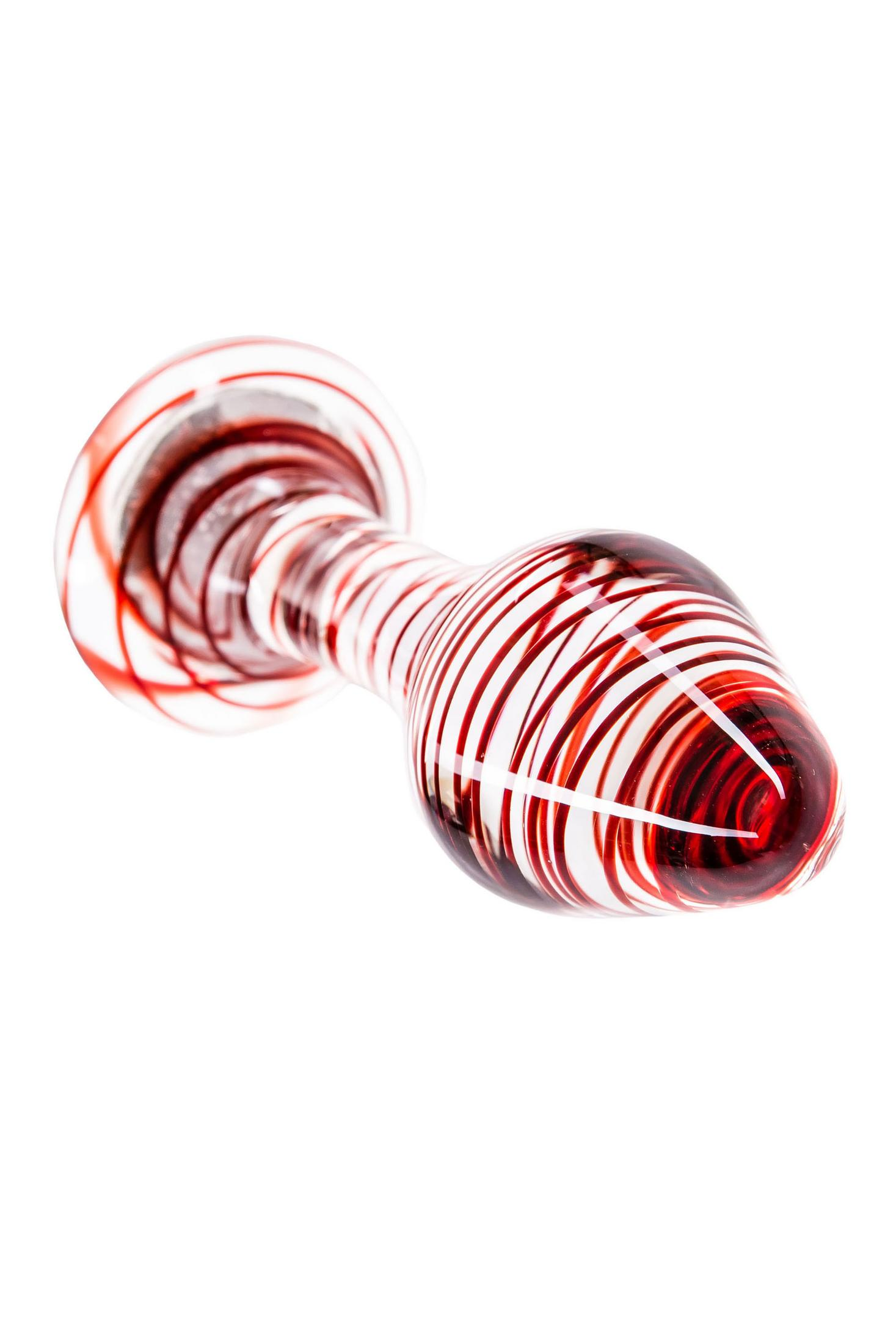 Ein Glasobjekt mit rotem Spiralmuster auf weißem Hintergrund.