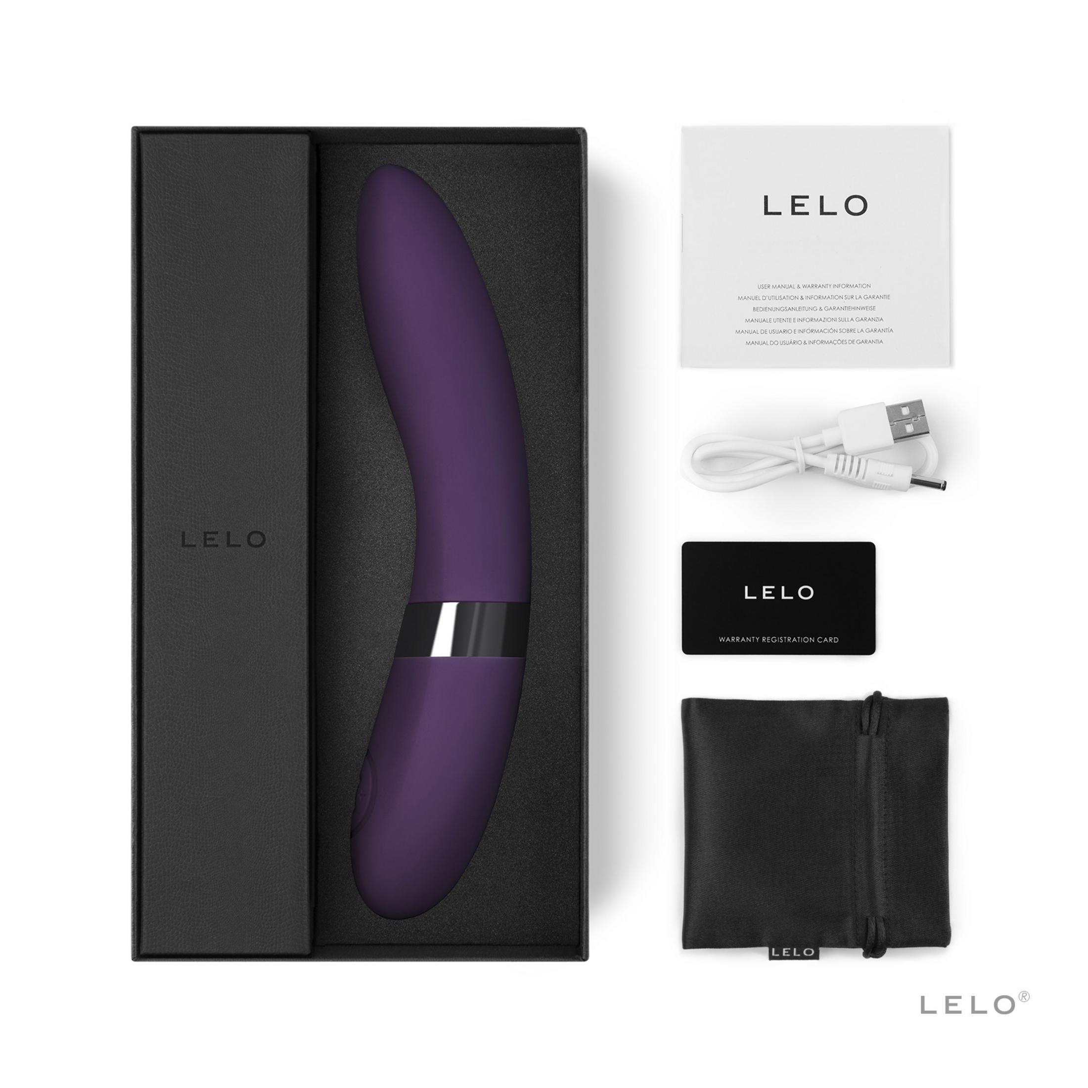 Un vibrador LELO morado en caja negra con manual, cable de carga y tarjeta.