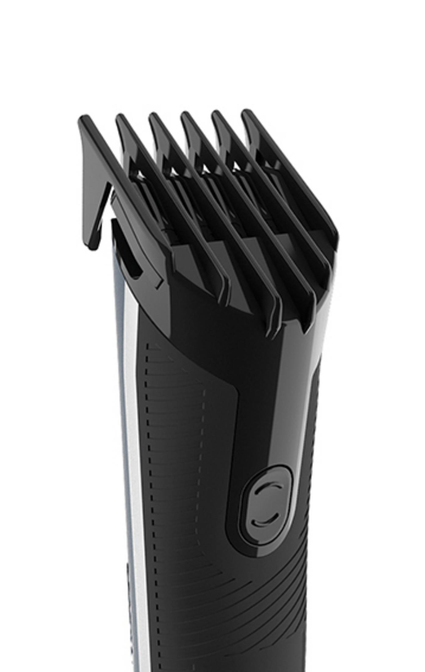 Close-up of a black hair clipper with a silver stripe and blades.