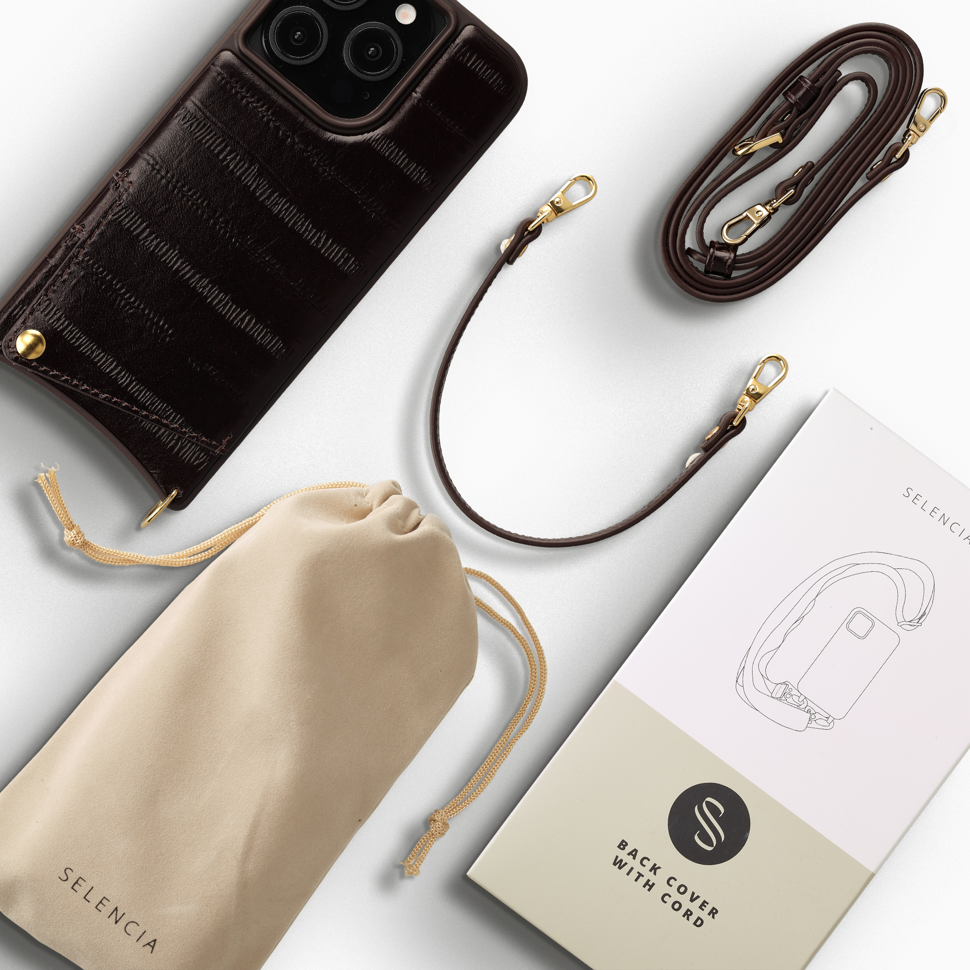 Coque de téléphone en cuir marron foncé avec sangle, pochette et boîte.