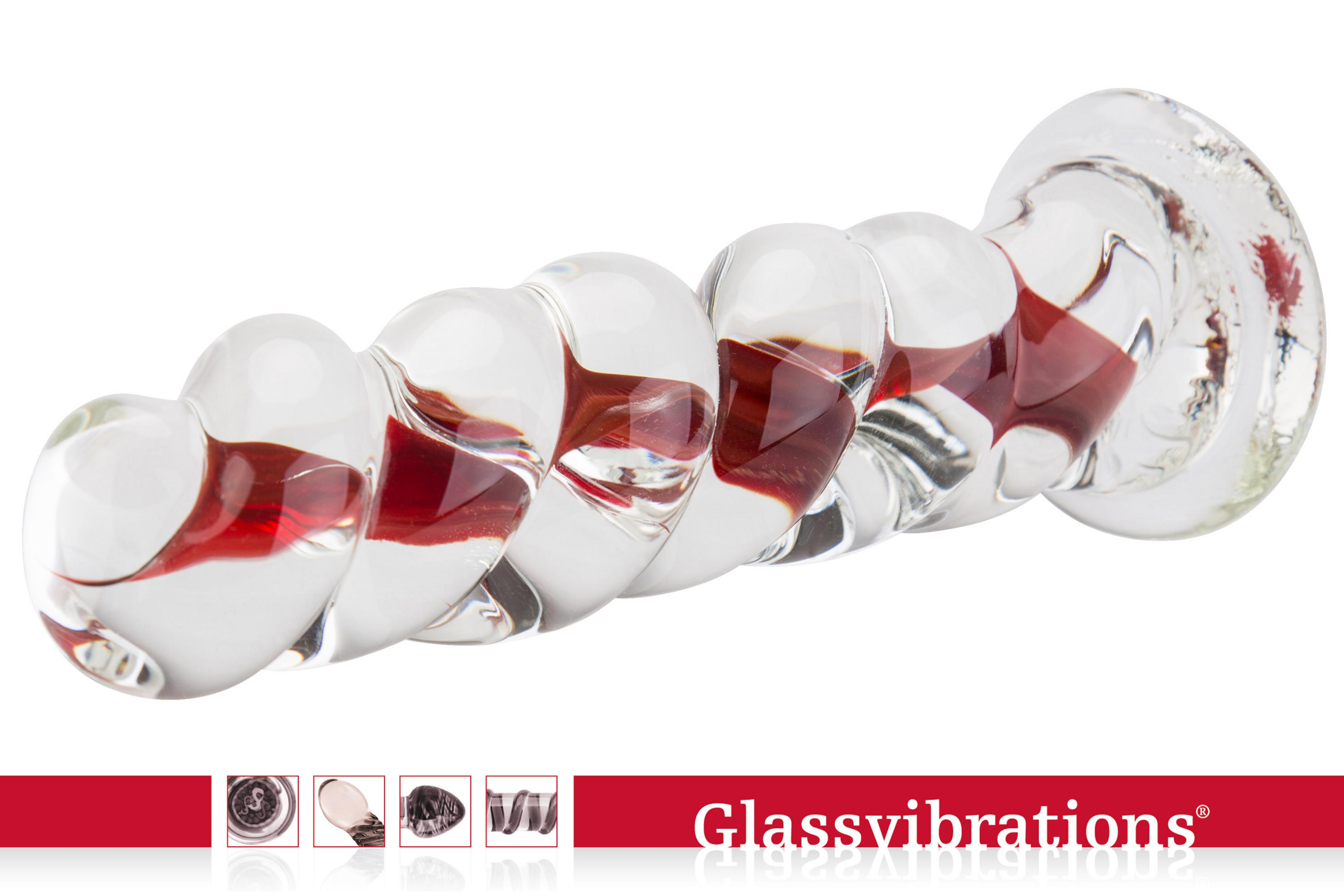 Ein klarer Glas-Vibrator mit roten spiralförmigen Einsätzen und einem breiten Griff.