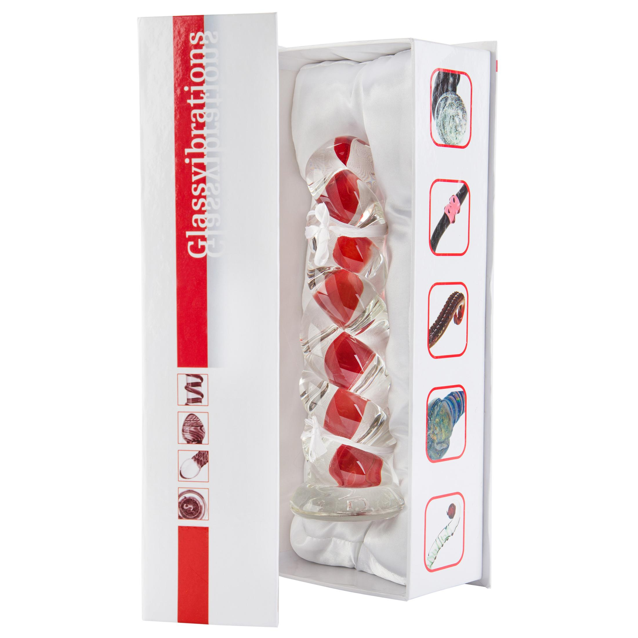 Glasobjekt mit roten Einschlüssen in einer weißen Geschenkbox, mit Bildern auf dem Karton.