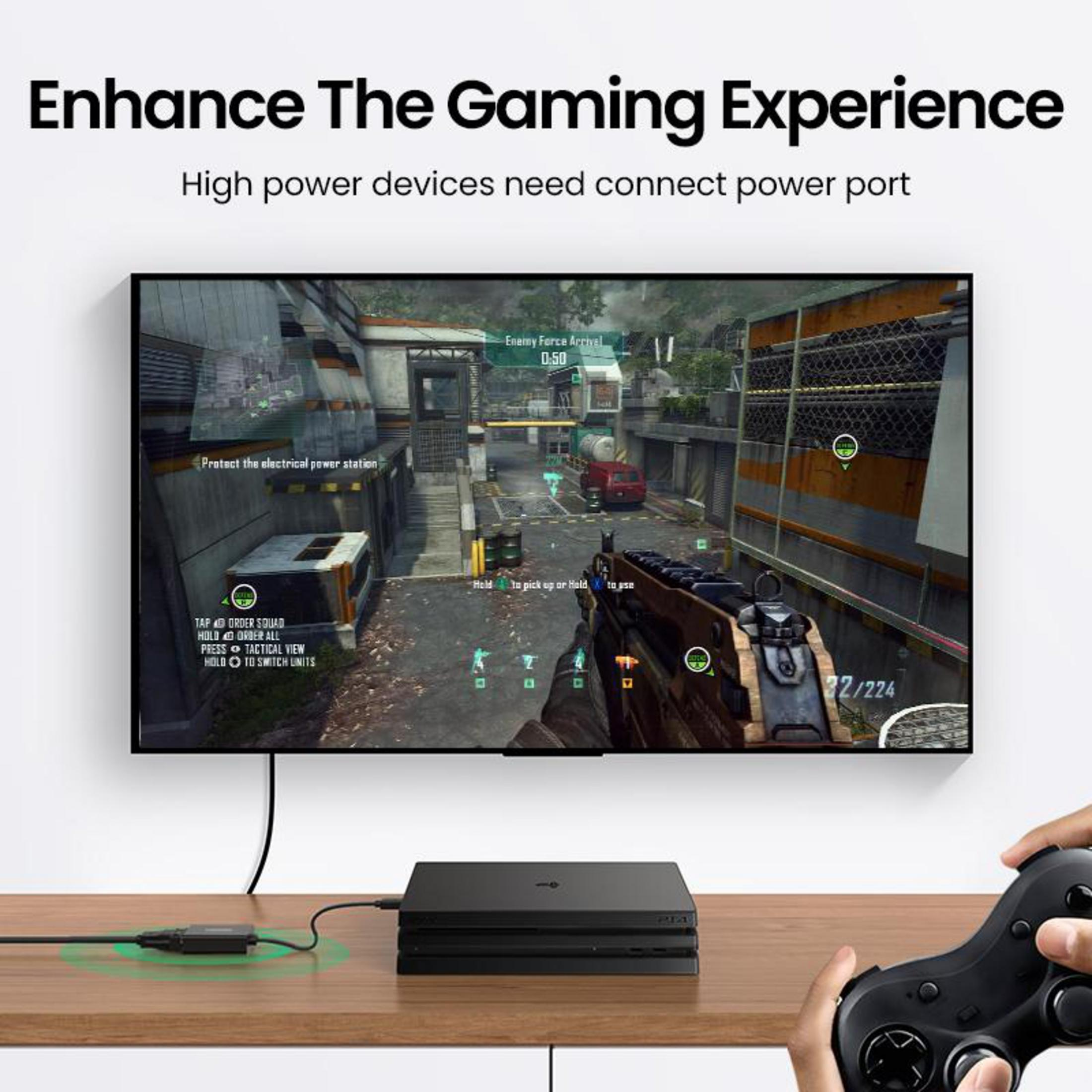 Ein schwarzer Gaming-PC ist auf einem Holztisch mit einem Controller und einem Fernseher zu sehen.
