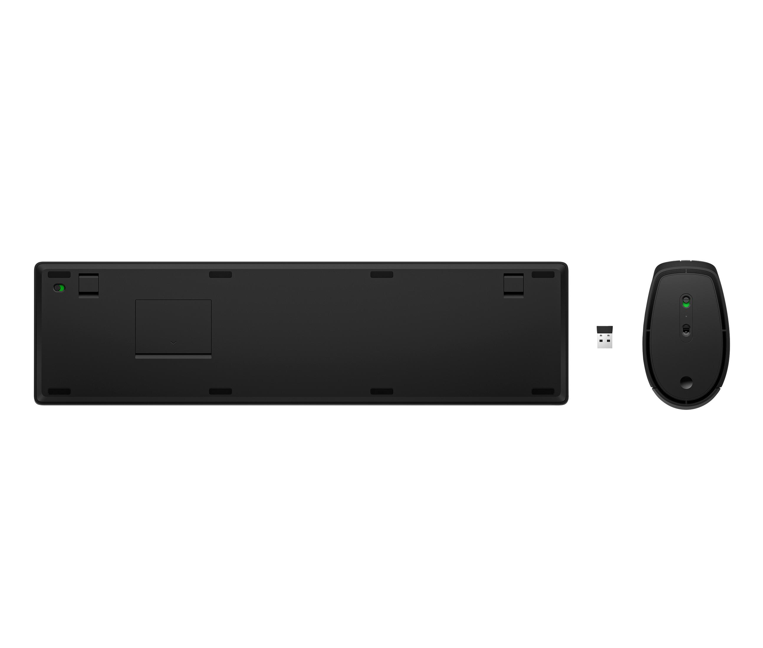 Arrière de clavier noir, souris et dongle USB sur fond blanc.